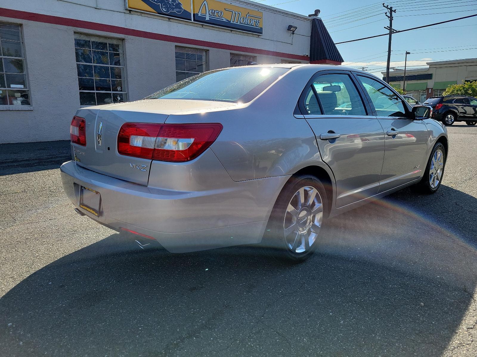 2007 Silver Birch Metallic - JP /Light Stone - T Lincoln MKZ (3LNHM26T77R) with an 3.5L DOHC 4V V6 DURATEC ENGINE engine, located at 50 Eastern Blvd., Essex, MD, 21221, (410) 686-3444, 39.304367, -76.484947 - Introducing the impressive 2007 Lincoln MKZ 4dr Sdn FWD. Finished in an elegant Silver Birch Metallic exterior and a sophisticated Light Stone - T interior, this ride delivers spectacular aesthetics. Under its hood revs a 3.5L DOHC 4V V6 Duratec engine, designed for seamless and efficient performanc - Photo #3