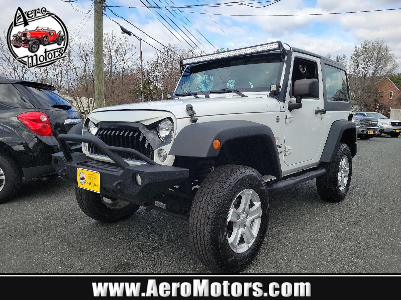 2015 Bright White Clearcoat - PW7 /Black - A7X9 Jeep Wrangler Sport (1C4AJWAGXFL) with an ENGINE: 3.6L V6 24V VVT engine, located at 50 Eastern Blvd., Essex, MD, 21221, (410) 686-3444, 39.304367, -76.484947 - Experience the thrill of off-road adventure with the 2015 Jeep Wrangler Sport 4WD 2dr Sport. This bold, white clearcoat exterior vehicle is powered by a 3.6L V6 24V VVT engine, ensuring unparalleled performance on any landscape. The accent-black interior imbues sophistication and comfort throughout - Photo #0