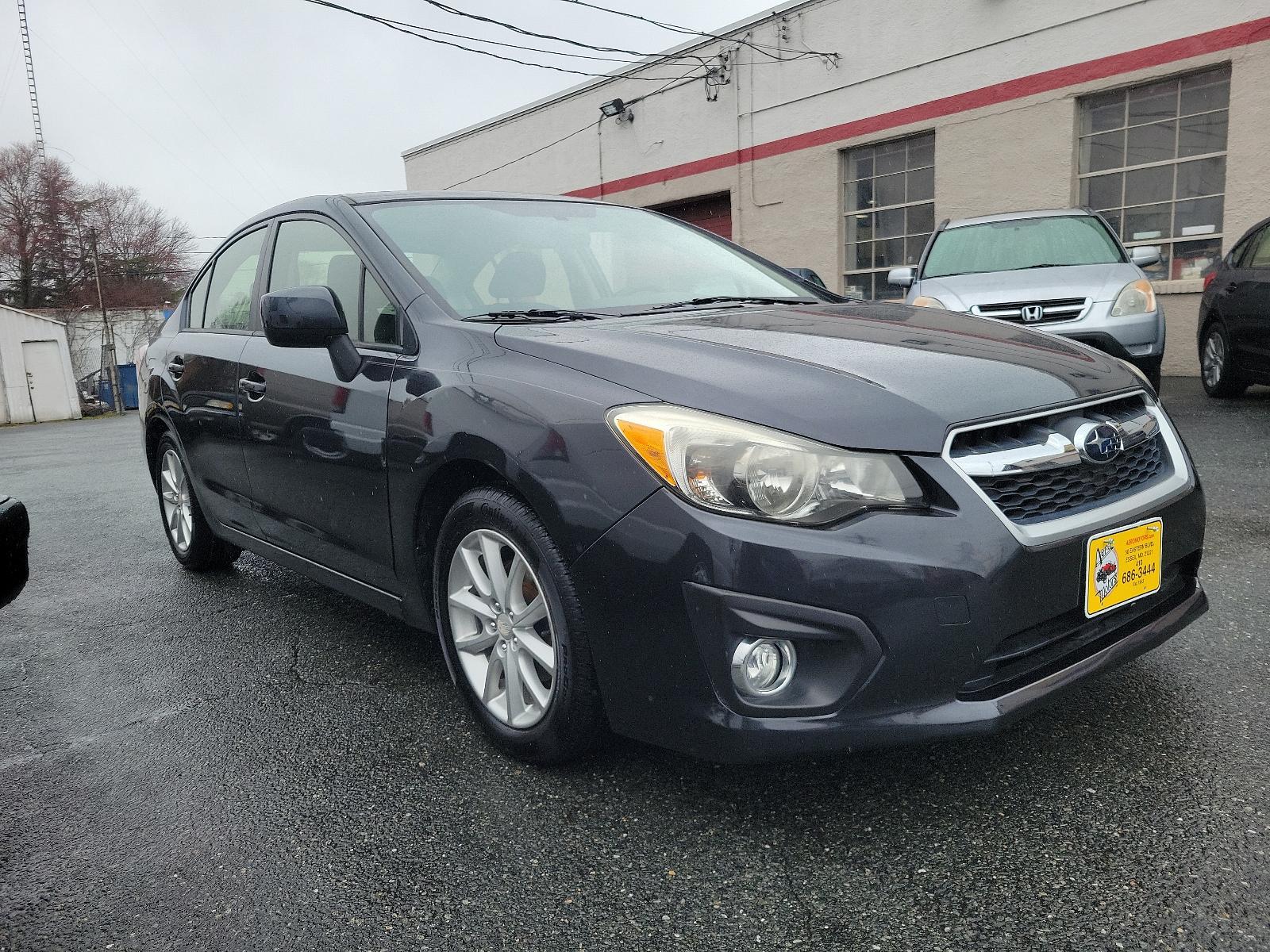 2014 Dark Gray Metallic - DGM /Black - BT20 Subaru Impreza Sedan Premium (JF1GJAC60EH) with an Engine: 2.0L DOHC 16V 4-Cylinder SMFI -inc: Electronic Throttle Control (ETC) engine, located at 50 Eastern Blvd., Essex, MD, 21221, (410) 686-3444, 39.304367, -76.484947 - Discover the thrill of driving in this sleek 2014 Subaru Impreza Sedan Premium, elegantly presented in a dark gray metallic exterior with a pristine black interior. This four-door marvel boasts a robust 2.0L DOHC 16V 4-Cylinder SMFI engine, designed with advanced electronic throttle control (ETC) to - Photo #2