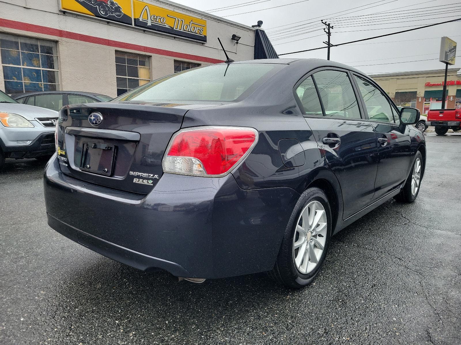 2014 Dark Gray Metallic - DGM /Black - BT20 Subaru Impreza Sedan Premium (JF1GJAC60EH) with an Engine: 2.0L DOHC 16V 4-Cylinder SMFI -inc: Electronic Throttle Control (ETC) engine, located at 50 Eastern Blvd., Essex, MD, 21221, (410) 686-3444, 39.304367, -76.484947 - Discover the thrill of driving in this sleek 2014 Subaru Impreza Sedan Premium, elegantly presented in a dark gray metallic exterior with a pristine black interior. This four-door marvel boasts a robust 2.0L DOHC 16V 4-Cylinder SMFI engine, designed with advanced electronic throttle control (ETC) to - Photo #3