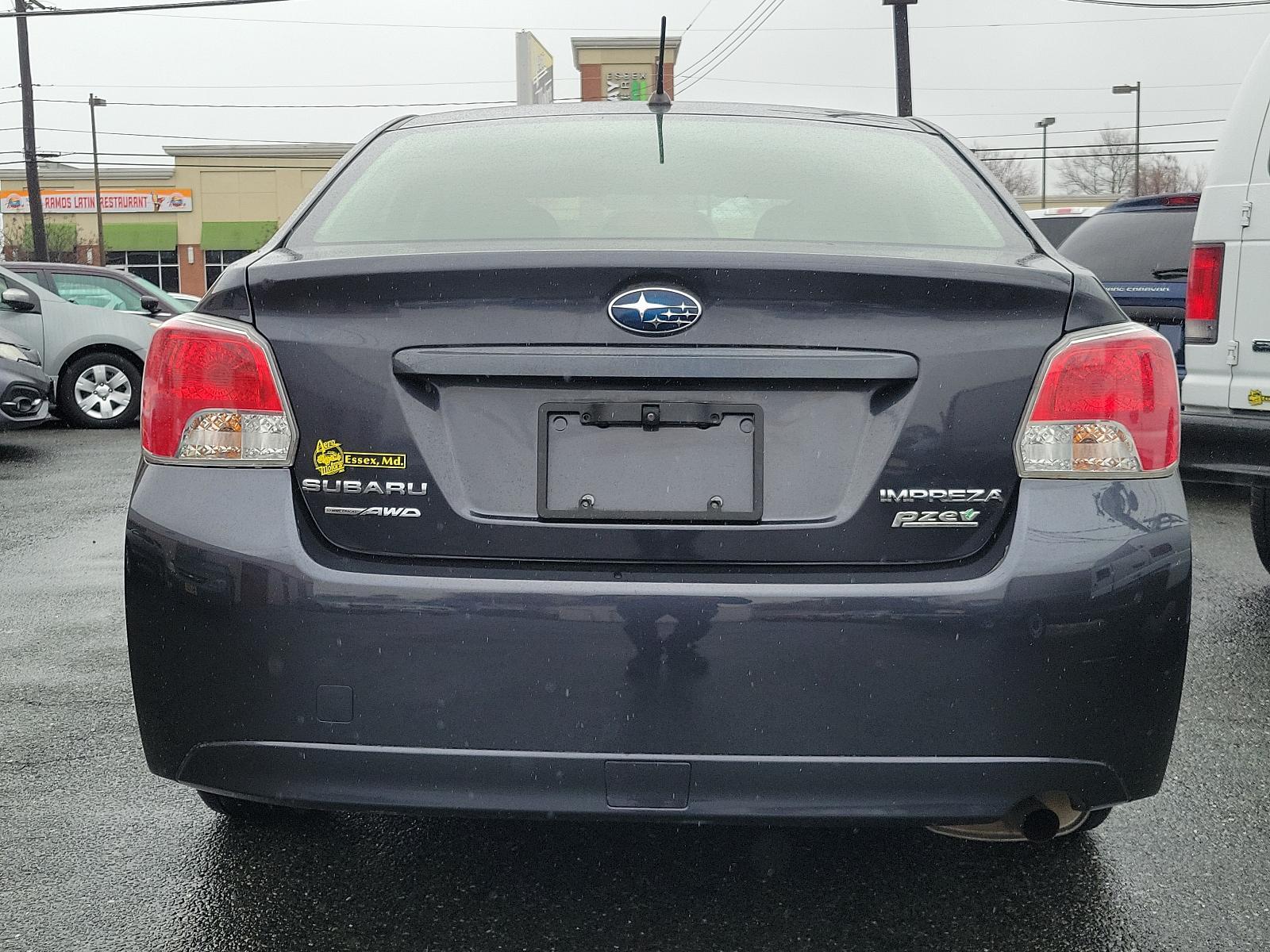 2014 Dark Gray Metallic - DGM /Black - BT20 Subaru Impreza Sedan Premium (JF1GJAC60EH) with an Engine: 2.0L DOHC 16V 4-Cylinder SMFI -inc: Electronic Throttle Control (ETC) engine, located at 50 Eastern Blvd., Essex, MD, 21221, (410) 686-3444, 39.304367, -76.484947 - Discover the thrill of driving in this sleek 2014 Subaru Impreza Sedan Premium, elegantly presented in a dark gray metallic exterior with a pristine black interior. This four-door marvel boasts a robust 2.0L DOHC 16V 4-Cylinder SMFI engine, designed with advanced electronic throttle control (ETC) to - Photo #4