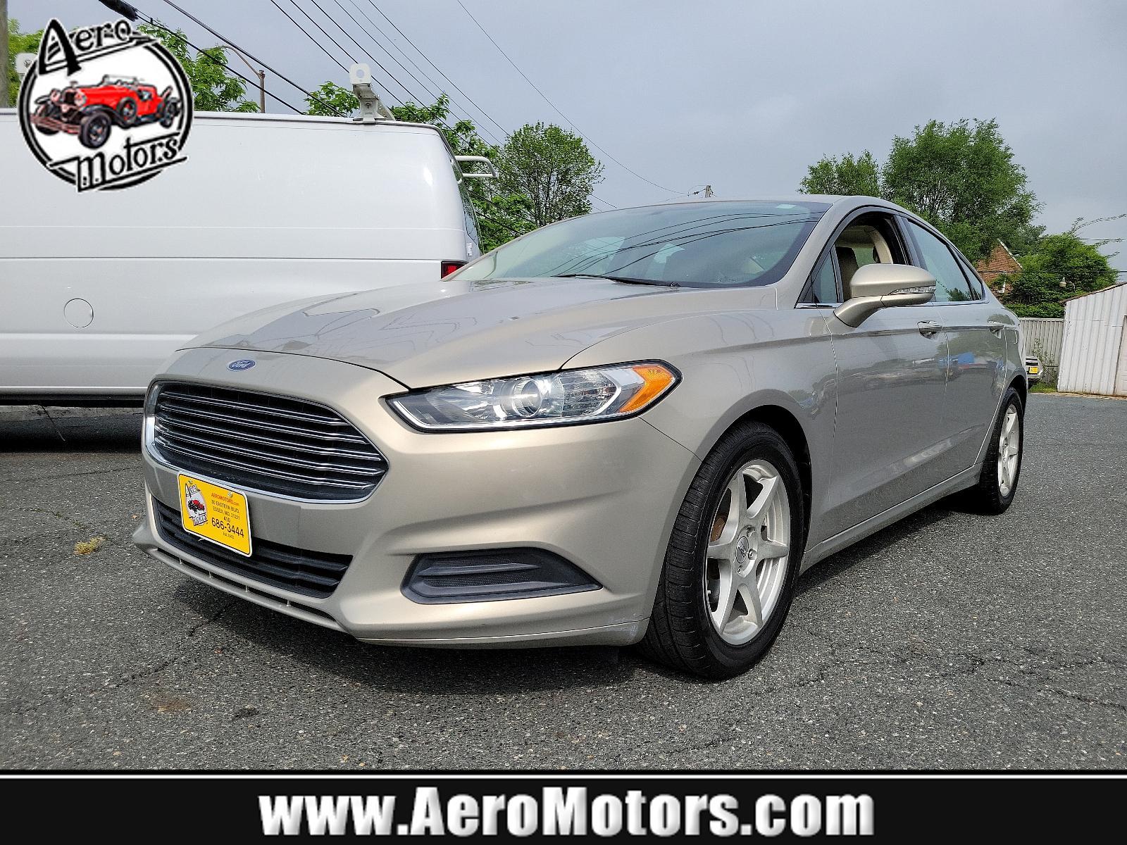2015 Tectonic - HI /Dune - AQ Ford Fusion SE (3FA6P0H71FR) with an ENGINE: 2.5L IVCT engine, located at 50 Eastern Blvd., Essex, MD, 21221, (410) 686-3444, 39.304367, -76.484947 - Experience the sophisticated blend of performance, efficiency, and style found in this 2015 Ford Fusion SE 4dr sdn se fwd. Unmistakably eye-catching with a sleek Tectonic-hi exterior, it exudes refinement and ivct technology with its sturdy 2.5L engine. This impressive engine ensures smooth, respons - Photo #0