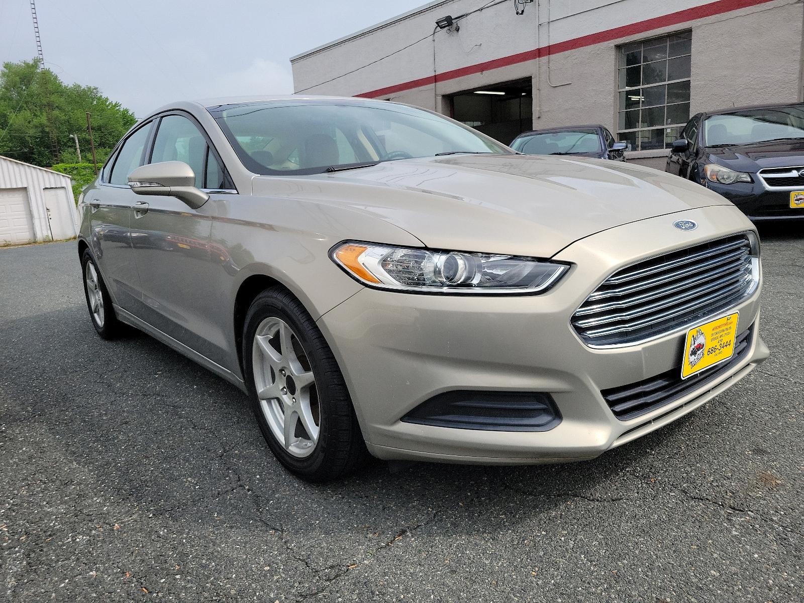 2015 Tectonic - HI /Dune - AQ Ford Fusion SE (3FA6P0H71FR) with an ENGINE: 2.5L IVCT engine, located at 50 Eastern Blvd., Essex, MD, 21221, (410) 686-3444, 39.304367, -76.484947 - Experience the sophisticated blend of performance, efficiency, and style found in this 2015 Ford Fusion SE 4dr sdn se fwd. Unmistakably eye-catching with a sleek Tectonic-hi exterior, it exudes refinement and ivct technology with its sturdy 2.5L engine. This impressive engine ensures smooth, respons - Photo #2