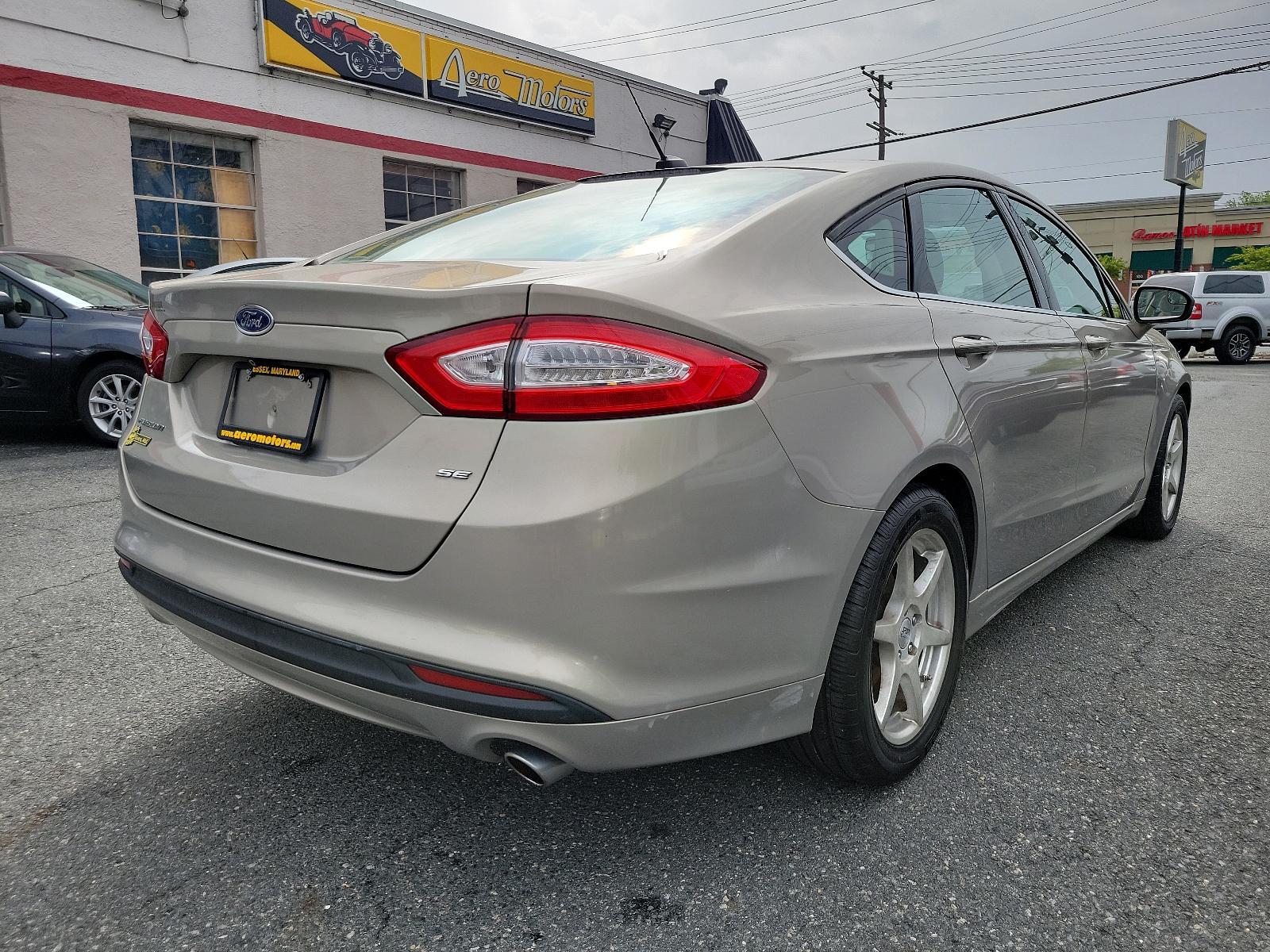 2015 Tectonic - HI /Dune - AQ Ford Fusion SE (3FA6P0H71FR) with an ENGINE: 2.5L IVCT engine, located at 50 Eastern Blvd., Essex, MD, 21221, (410) 686-3444, 39.304367, -76.484947 - Experience the sophisticated blend of performance, efficiency, and style found in this 2015 Ford Fusion SE 4dr sdn se fwd. Unmistakably eye-catching with a sleek Tectonic-hi exterior, it exudes refinement and ivct technology with its sturdy 2.5L engine. This impressive engine ensures smooth, respons - Photo #3