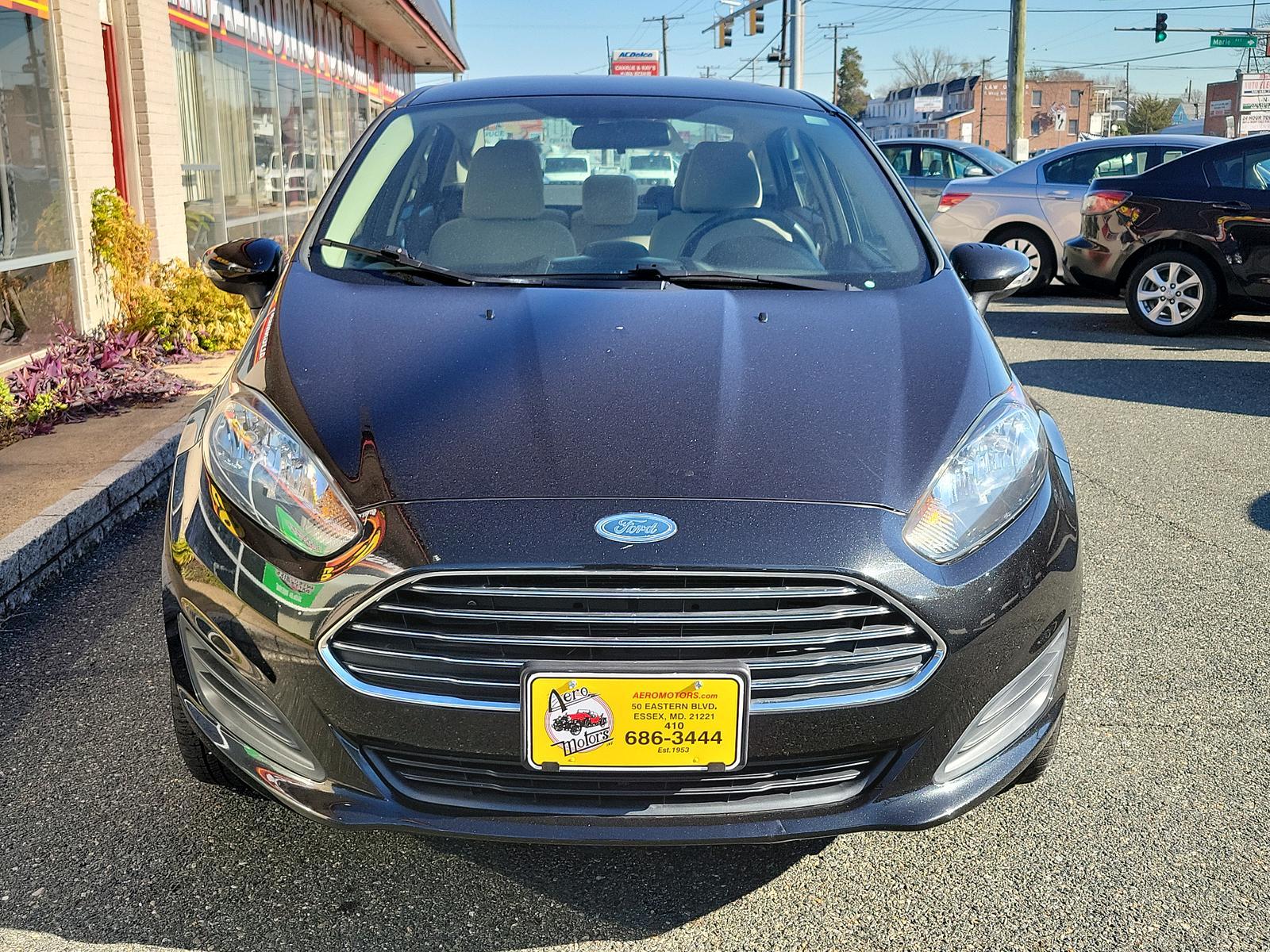 2014 Tuxedo Black Metallic /Medium Light Stone Ford Fiesta SE (3FADP4BJ1EM) with an ENGINE: 1.6L TI-VCT I-4 engine, located at 50 Eastern Blvd., Essex, MD, 21221, (410) 686-3444, 39.304367, -76.484947 - Look at this 2014 Ford Fiesta SE Sedan shown in Tuxedo Black. This subcompact is powered by a 1.6 Liter Ti-VCT 4 Cylinder that offers 120hp while paired to a 6 Speed Automatic transmission to give you with plenty of zip. This Front Wheel Drive sedan offers you nearly 39mpg on the highway. You will l - Photo #1