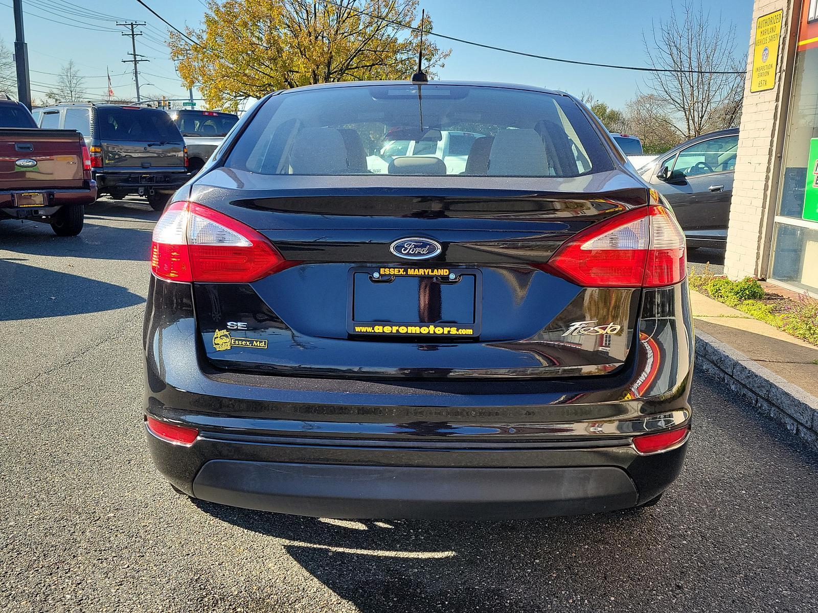 2014 Tuxedo Black Metallic /Medium Light Stone Ford Fiesta SE (3FADP4BJ1EM) with an ENGINE: 1.6L TI-VCT I-4 engine, located at 50 Eastern Blvd., Essex, MD, 21221, (410) 686-3444, 39.304367, -76.484947 - Look at this 2014 Ford Fiesta SE Sedan shown in Tuxedo Black. This subcompact is powered by a 1.6 Liter Ti-VCT 4 Cylinder that offers 120hp while paired to a 6 Speed Automatic transmission to give you with plenty of zip. This Front Wheel Drive sedan offers you nearly 39mpg on the highway. You will l - Photo #4