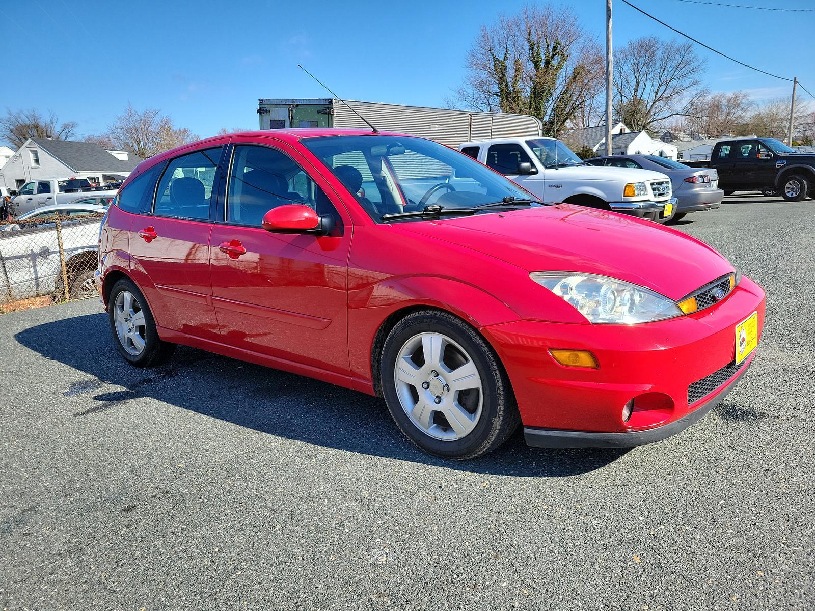 2003 Infra Red - E4 /Black/Red - R Ford Focus ZX5 Comfort (3FAHP37553R) , located at 50 Eastern Blvd., Essex, MD, 21221, (410) 686-3444, 39.304367, -76.484947 - <p>Our 2003 Ford Focus ZX5 Comfort Hatchback in Infra Red is a great choice for your active lifestyle! Powered by a 2.3 Liter 4 Cylinder generating 145hp connected to a 5 Speed Manual transmission. This Front Wheel Drive hatchback shows off with up to 33mpg on the highway and unique styling. Power m - Photo #2
