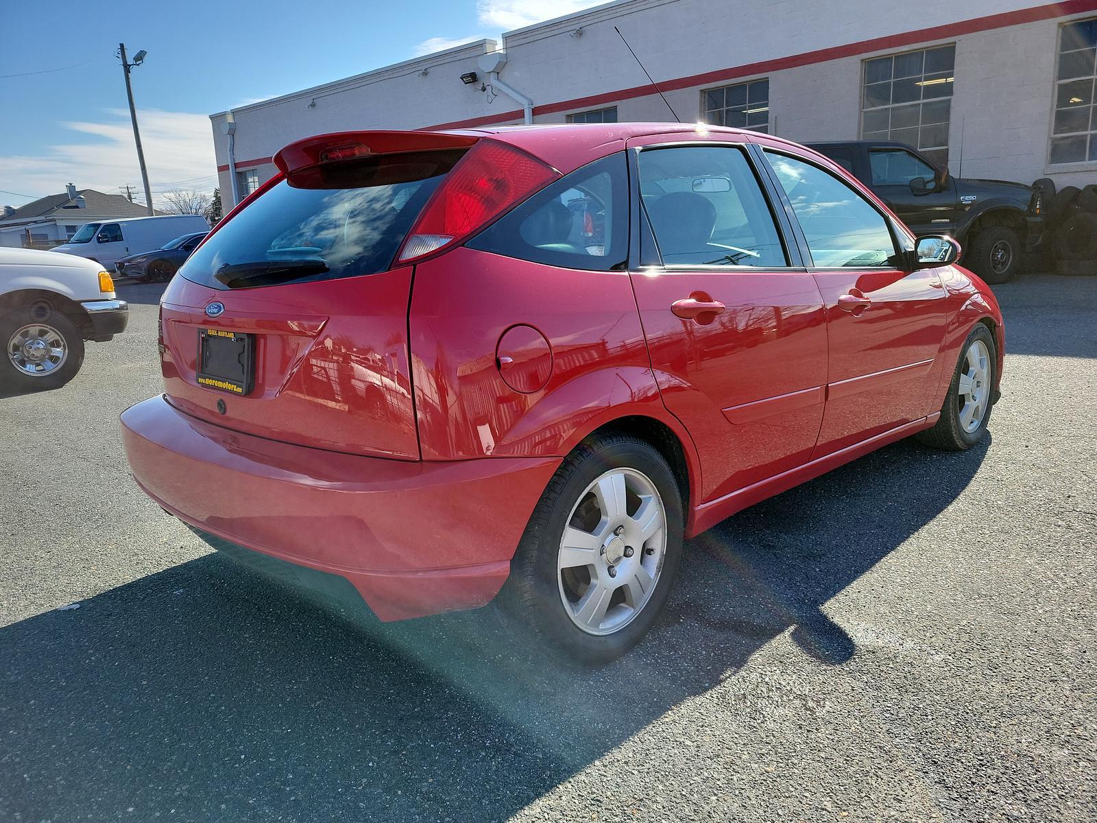 2003 Infra Red - E4 /Black/Red - R Ford Focus ZX5 Comfort (3FAHP37553R) , located at 50 Eastern Blvd., Essex, MD, 21221, (410) 686-3444, 39.304367, -76.484947 - <p>Our 2003 Ford Focus ZX5 Comfort Hatchback in Infra Red is a great choice for your active lifestyle! Powered by a 2.3 Liter 4 Cylinder generating 145hp connected to a 5 Speed Manual transmission. This Front Wheel Drive hatchback shows off with up to 33mpg on the highway and unique styling. Power m - Photo #3