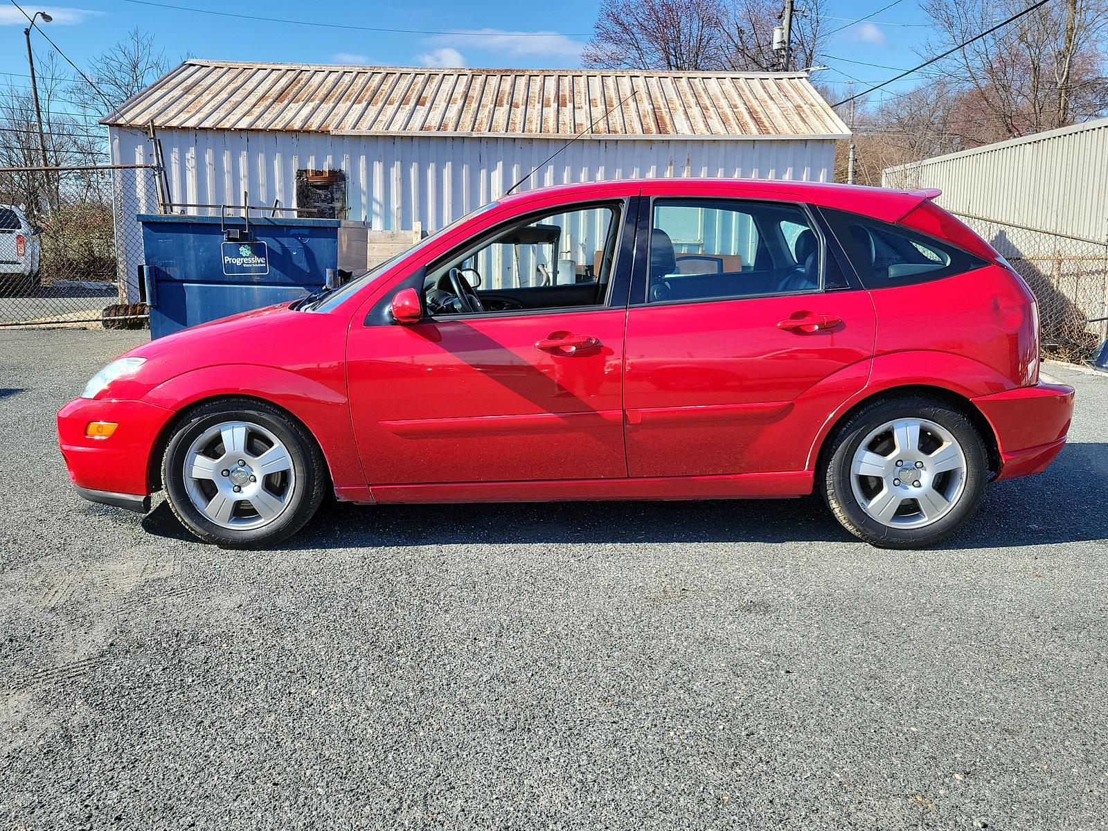 2003 Infra Red - E4 /Black/Red - R Ford Focus ZX5 Comfort (3FAHP37553R) , located at 50 Eastern Blvd., Essex, MD, 21221, (410) 686-3444, 39.304367, -76.484947 - <p>Our 2003 Ford Focus ZX5 Comfort Hatchback in Infra Red is a great choice for your active lifestyle! Powered by a 2.3 Liter 4 Cylinder generating 145hp connected to a 5 Speed Manual transmission. This Front Wheel Drive hatchback shows off with up to 33mpg on the highway and unique styling. Power m - Photo #5