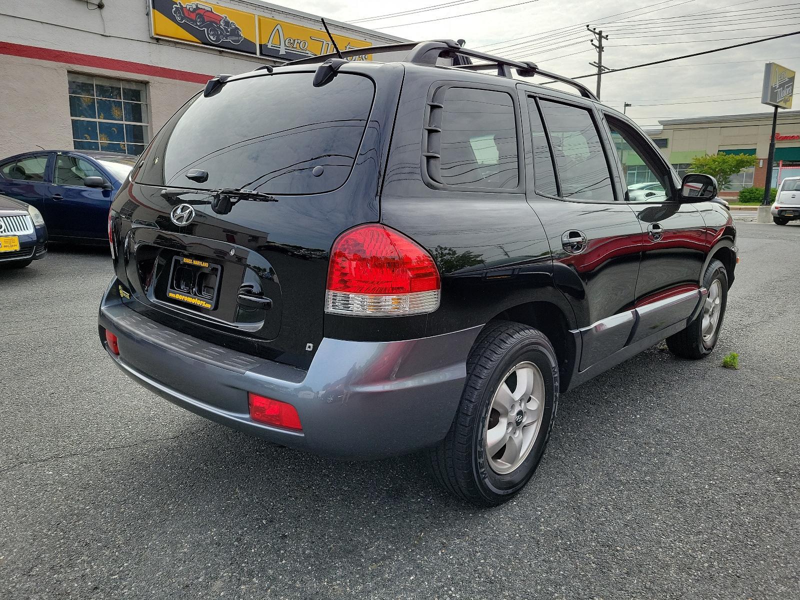 2006 Black Obsidian - ED /Gray - YD Hyundai Santa Fe GLS (KM8SC73D56U) with an 2.7L DOHC MPI 24-valve V6 engine engine, located at 50 Eastern Blvd., Essex, MD, 21221, (410) 686-3444, 39.304367, -76.484947 - <p>Our 2006 Hyundai Santa Fe GLS 4WD in Black Obsidian blends the best attributes of traditional SUVs with a driving character like that of a mid-sized sedan. Powered by a 2.7 Liter V6 generating 200hp coupled to a 5 Speed Automatic transmission. This Four Wheel Drive SUV earns up to mpg on the high - Photo #3