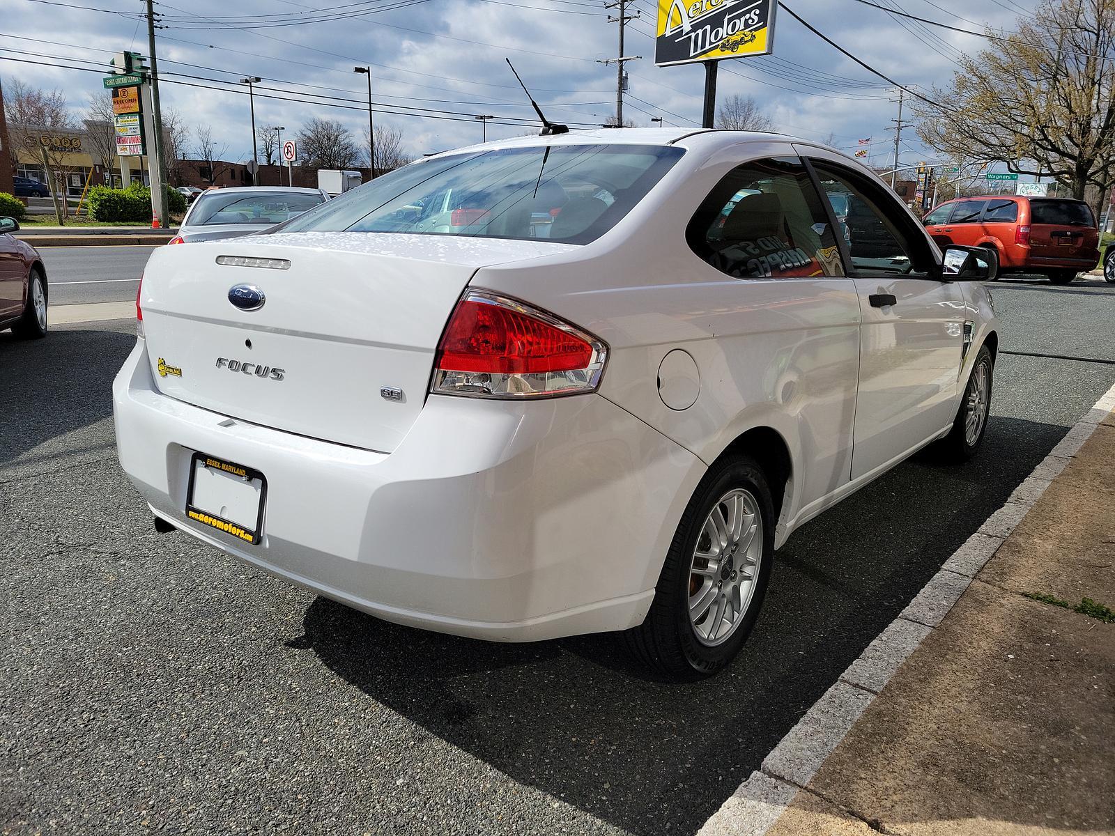 2008 Oxford White - YZ /Medium Stone - S Ford Focus SE (1FAHP33N48W) with an 2.0L DOHC 16-VALVE I4 DURATEC ENGINE engine, located at 50 Eastern Blvd., Essex, MD, 21221, (410) 686-3444, 39.304367, -76.484947 - <p>This 2008 Ford Focus SE Coupe shown in Oxford White should be on your shortlist. Powered by a 2.0 Liter 4 Cylinder that generates 132hp while combined with an Automatic transmission. This Front Wheel Drive accelerates briskly and loves to show the pep in its step while scoring near 35mpg on the h - Photo #3