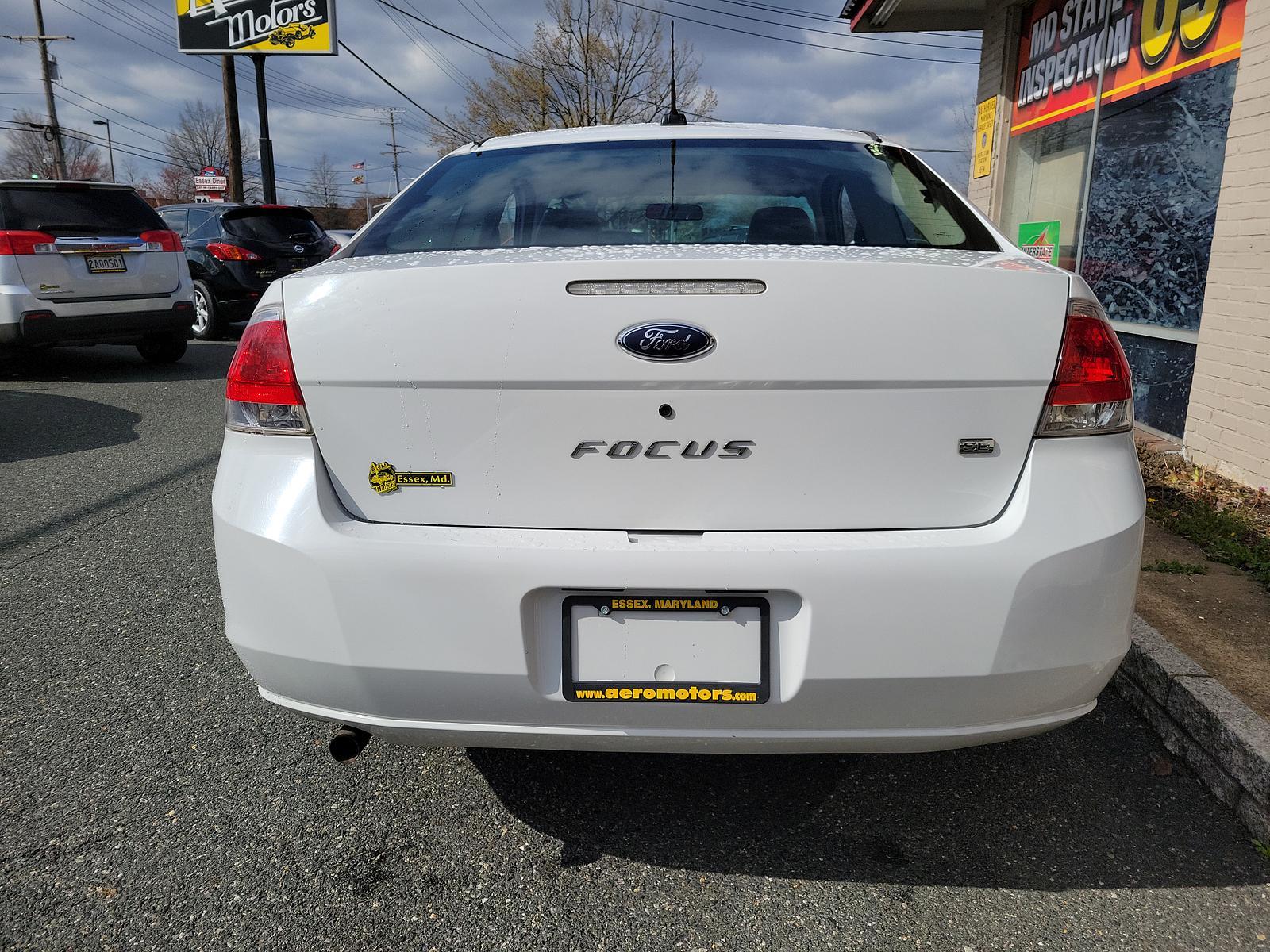 2008 Oxford White - YZ /Medium Stone - S Ford Focus SE (1FAHP33N48W) with an 2.0L DOHC 16-VALVE I4 DURATEC ENGINE engine, located at 50 Eastern Blvd., Essex, MD, 21221, (410) 686-3444, 39.304367, -76.484947 - <p>This 2008 Ford Focus SE Coupe shown in Oxford White should be on your shortlist. Powered by a 2.0 Liter 4 Cylinder that generates 132hp while combined with an Automatic transmission. This Front Wheel Drive accelerates briskly and loves to show the pep in its step while scoring near 35mpg on the h - Photo #4