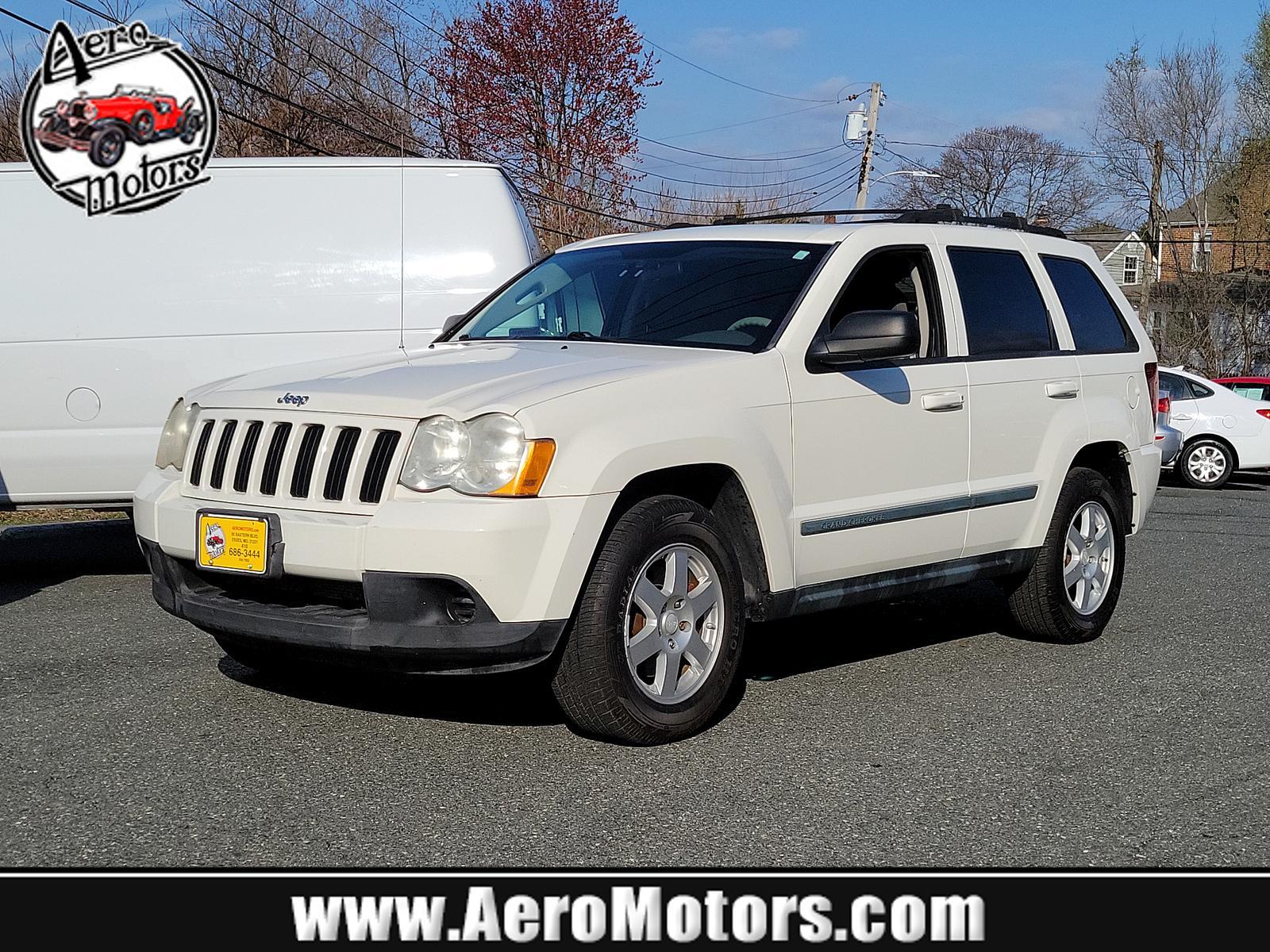 2009 Stone White - PW1 /Khaki - ELJ3 Jeep Grand Cherokee Laredo (1J8GR48K69C) with an 3.7L V6 ENGINE engine, located at 50 Eastern Blvd., Essex, MD, 21221, (410) 686-3444, 39.304367, -76.484947 - <p>Our incredible 2009 Jeep Grand Cherokee Laredo is shown off in Stone White. Powered by a strong 3.7 Liter V6 generating 210hp while connected to a durable 5 Speed Automatic transmission for easy passing. This Rear Wheel Drive SUV has plenty of power for both city traffic and swift highway cruisin - Photo #0