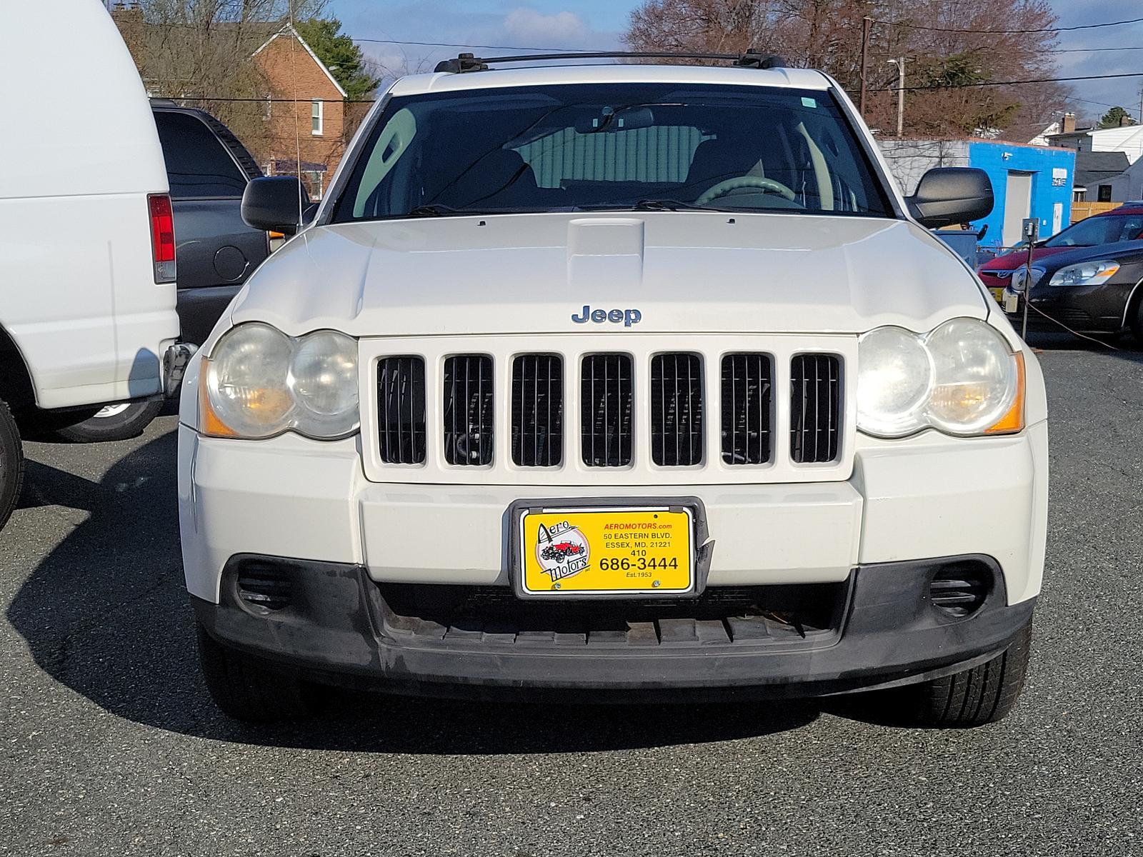 2009 Stone White - PW1 /Khaki - ELJ3 Jeep Grand Cherokee Laredo (1J8GR48K69C) with an 3.7L V6 ENGINE engine, located at 50 Eastern Blvd., Essex, MD, 21221, (410) 686-3444, 39.304367, -76.484947 - <p>Our incredible 2009 Jeep Grand Cherokee Laredo is shown off in Stone White. Powered by a strong 3.7 Liter V6 generating 210hp while connected to a durable 5 Speed Automatic transmission for easy passing. This Rear Wheel Drive SUV has plenty of power for both city traffic and swift highway cruisin - Photo #1