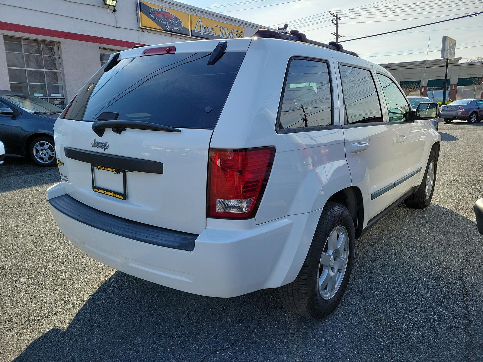 2009 Stone White - PW1 /Khaki - ELJ3 Jeep Grand Cherokee Laredo (1J8GR48K69C) with an 3.7L V6 ENGINE engine, located at 50 Eastern Blvd., Essex, MD, 21221, (410) 686-3444, 39.304367, -76.484947 - <p>Our incredible 2009 Jeep Grand Cherokee Laredo is shown off in Stone White. Powered by a strong 3.7 Liter V6 generating 210hp while connected to a durable 5 Speed Automatic transmission for easy passing. This Rear Wheel Drive SUV has plenty of power for both city traffic and swift highway cruisin - Photo #3