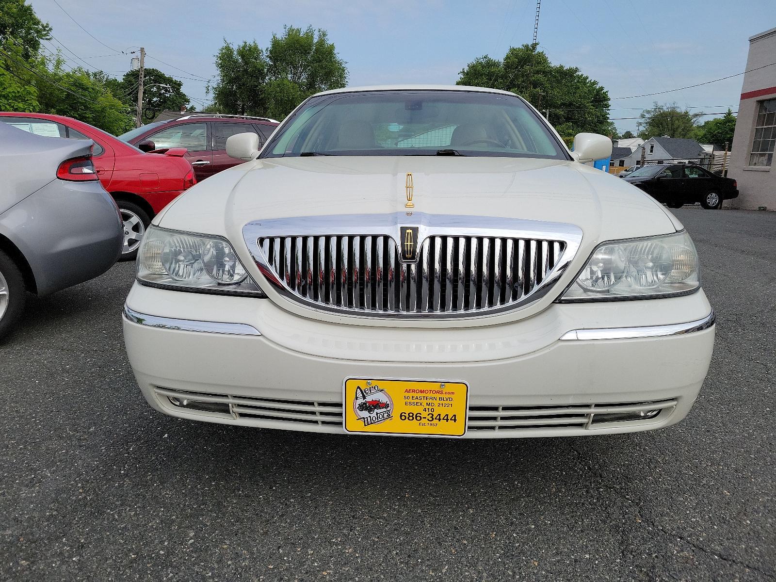 2003 Ceramic White - F6 /Light Parchment - F Lincoln Town Car Cartier Premium (1LNHM83W03Y) with an 4.6L SOHC SMPI V8 ENGINE engine, located at 50 Eastern Blvd., Essex, MD, 21221, (410) 686-3444, 39.304367, -76.484947 - <p>Full-size luxury at its finest, introducing our 2003 Lincoln Town Car Cartier Premium Sedan showcased in Ceramic White. Powered by a 4.6 Liter V8 generating 239hp paired with a 4 Speed Automatic transmission. This Rear Wheel Drive sedan's smooth lines and chrome wheels help it earn up to 25mpg on - Photo #1
