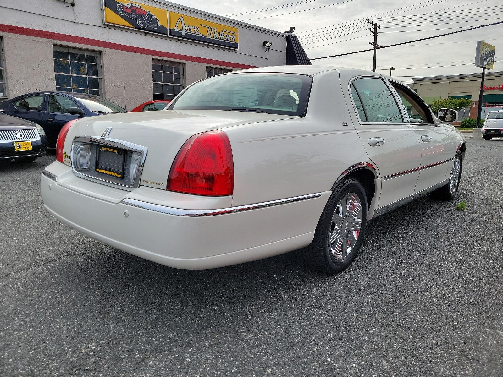 2003 Ceramic White - F6 /Light Parchment - F Lincoln Town Car Cartier Premium (1LNHM83W03Y) with an 4.6L SOHC SMPI V8 ENGINE engine, located at 50 Eastern Blvd., Essex, MD, 21221, (410) 686-3444, 39.304367, -76.484947 - <p>Full-size luxury at its finest, introducing our 2003 Lincoln Town Car Cartier Premium Sedan showcased in Ceramic White. Powered by a 4.6 Liter V8 generating 239hp paired with a 4 Speed Automatic transmission. This Rear Wheel Drive sedan's smooth lines and chrome wheels help it earn up to 25mpg on - Photo #3