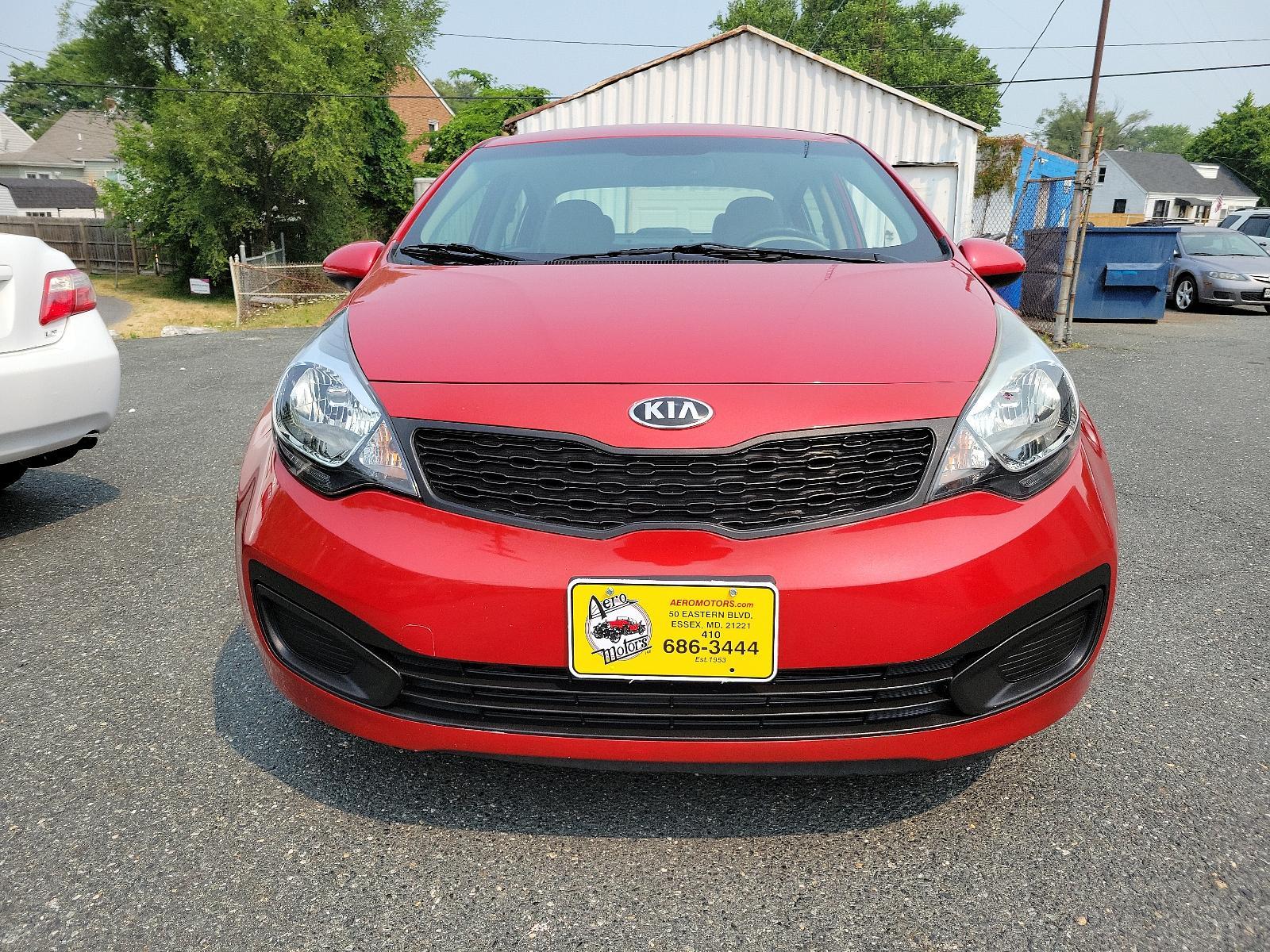 2013 Signal Red - BEG /Beige - DCM Kia Rio LX (KNADM4A32D6) with an 1.6L DOHC GDI dual CVVT 16-valve I4 engine -inc: variable intake system (VIS), aluminum block and head, full-size engine cover engine, located at 50 Eastern Blvd., Essex, MD, 21221, (410) 686-3444, 39.304367, -76.484947 - <p>You've found our sporty and ultra-efficient 2013 Kia Rio LX Sedan shown in Signal Red. Powered by a 1.6 Liter 4 Cylinder that delivers 138hp paired to the smooth-shifting 6 Speed Automatic transmission gives excellent passing power. You can achieve nearly 40mpg on the road with Front Wheel Drive. - Photo #1