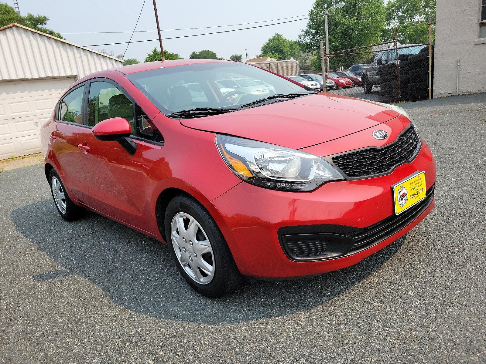 2013 Signal Red - BEG /Beige - DCM Kia Rio LX (KNADM4A32D6) with an 1.6L DOHC GDI dual CVVT 16-valve I4 engine -inc: variable intake system (VIS), aluminum block and head, full-size engine cover engine, located at 50 Eastern Blvd., Essex, MD, 21221, (410) 686-3444, 39.304367, -76.484947 - <p>You've found our sporty and ultra-efficient 2013 Kia Rio LX Sedan shown in Signal Red. Powered by a 1.6 Liter 4 Cylinder that delivers 138hp paired to the smooth-shifting 6 Speed Automatic transmission gives excellent passing power. You can achieve nearly 40mpg on the road with Front Wheel Drive. - Photo #2
