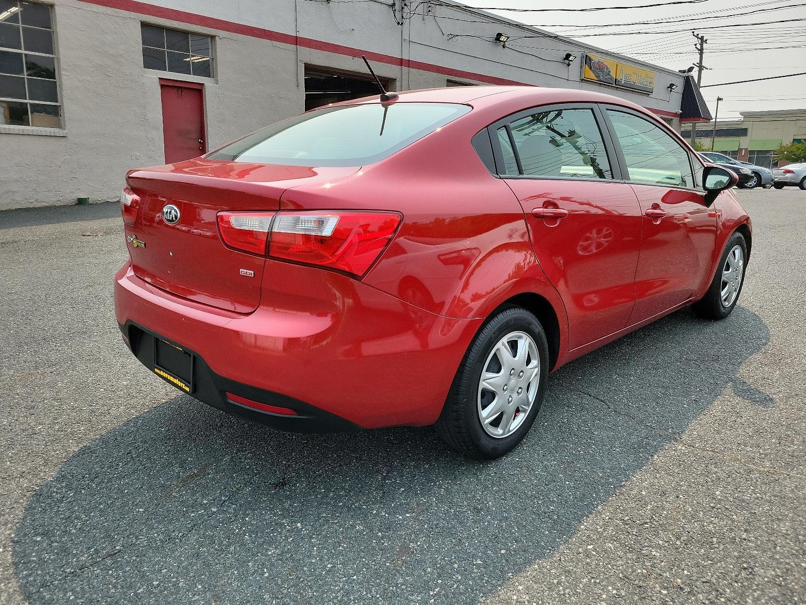 2013 Signal Red - BEG /Beige - DCM Kia Rio LX (KNADM4A32D6) with an 1.6L DOHC GDI dual CVVT 16-valve I4 engine -inc: variable intake system (VIS), aluminum block and head, full-size engine cover engine, located at 50 Eastern Blvd., Essex, MD, 21221, (410) 686-3444, 39.304367, -76.484947 - <p>You've found our sporty and ultra-efficient 2013 Kia Rio LX Sedan shown in Signal Red. Powered by a 1.6 Liter 4 Cylinder that delivers 138hp paired to the smooth-shifting 6 Speed Automatic transmission gives excellent passing power. You can achieve nearly 40mpg on the road with Front Wheel Drive. - Photo #3