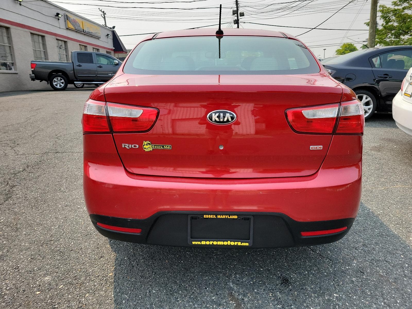 2013 Signal Red - BEG /Beige - DCM Kia Rio LX (KNADM4A32D6) with an 1.6L DOHC GDI dual CVVT 16-valve I4 engine -inc: variable intake system (VIS), aluminum block and head, full-size engine cover engine, located at 50 Eastern Blvd., Essex, MD, 21221, (410) 686-3444, 39.304367, -76.484947 - <p>You've found our sporty and ultra-efficient 2013 Kia Rio LX Sedan shown in Signal Red. Powered by a 1.6 Liter 4 Cylinder that delivers 138hp paired to the smooth-shifting 6 Speed Automatic transmission gives excellent passing power. You can achieve nearly 40mpg on the road with Front Wheel Drive. - Photo #4