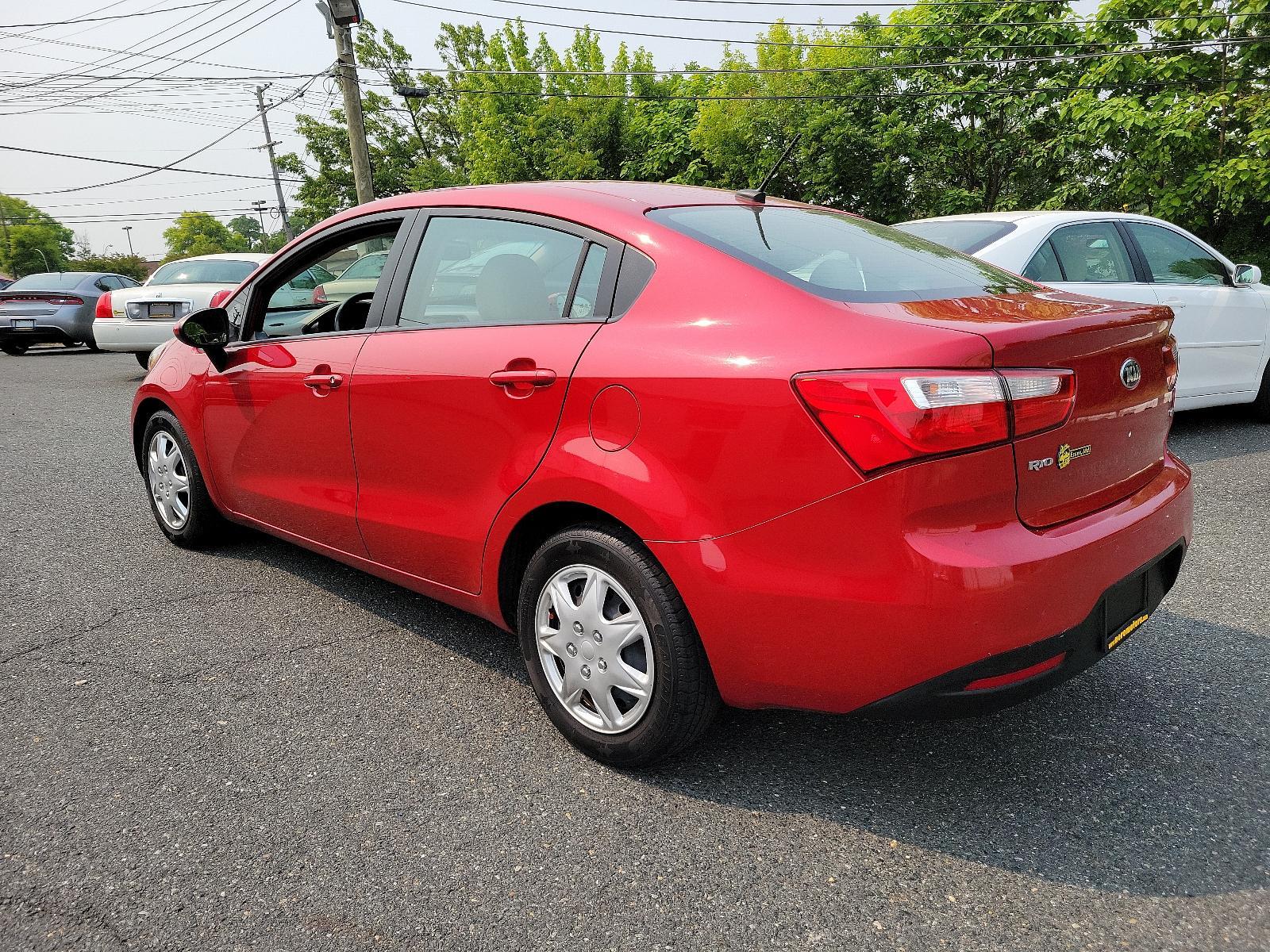 2013 Signal Red - BEG /Beige - DCM Kia Rio LX (KNADM4A32D6) with an 1.6L DOHC GDI dual CVVT 16-valve I4 engine -inc: variable intake system (VIS), aluminum block and head, full-size engine cover engine, located at 50 Eastern Blvd., Essex, MD, 21221, (410) 686-3444, 39.304367, -76.484947 - <p>You've found our sporty and ultra-efficient 2013 Kia Rio LX Sedan shown in Signal Red. Powered by a 1.6 Liter 4 Cylinder that delivers 138hp paired to the smooth-shifting 6 Speed Automatic transmission gives excellent passing power. You can achieve nearly 40mpg on the road with Front Wheel Drive. - Photo #5
