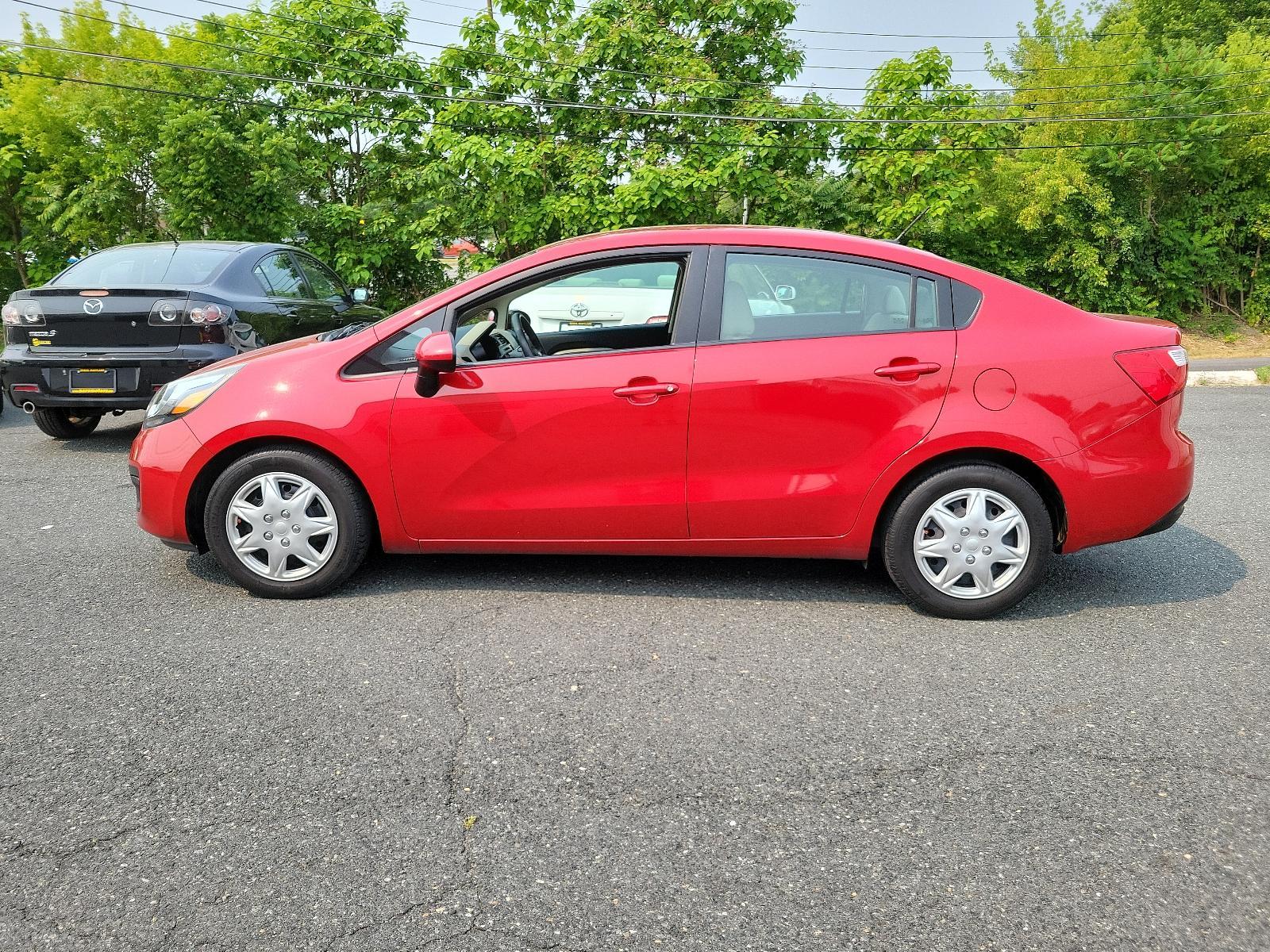 2013 Signal Red - BEG /Beige - DCM Kia Rio LX (KNADM4A32D6) with an 1.6L DOHC GDI dual CVVT 16-valve I4 engine -inc: variable intake system (VIS), aluminum block and head, full-size engine cover engine, located at 50 Eastern Blvd., Essex, MD, 21221, (410) 686-3444, 39.304367, -76.484947 - <p>You've found our sporty and ultra-efficient 2013 Kia Rio LX Sedan shown in Signal Red. Powered by a 1.6 Liter 4 Cylinder that delivers 138hp paired to the smooth-shifting 6 Speed Automatic transmission gives excellent passing power. You can achieve nearly 40mpg on the road with Front Wheel Drive. - Photo #6