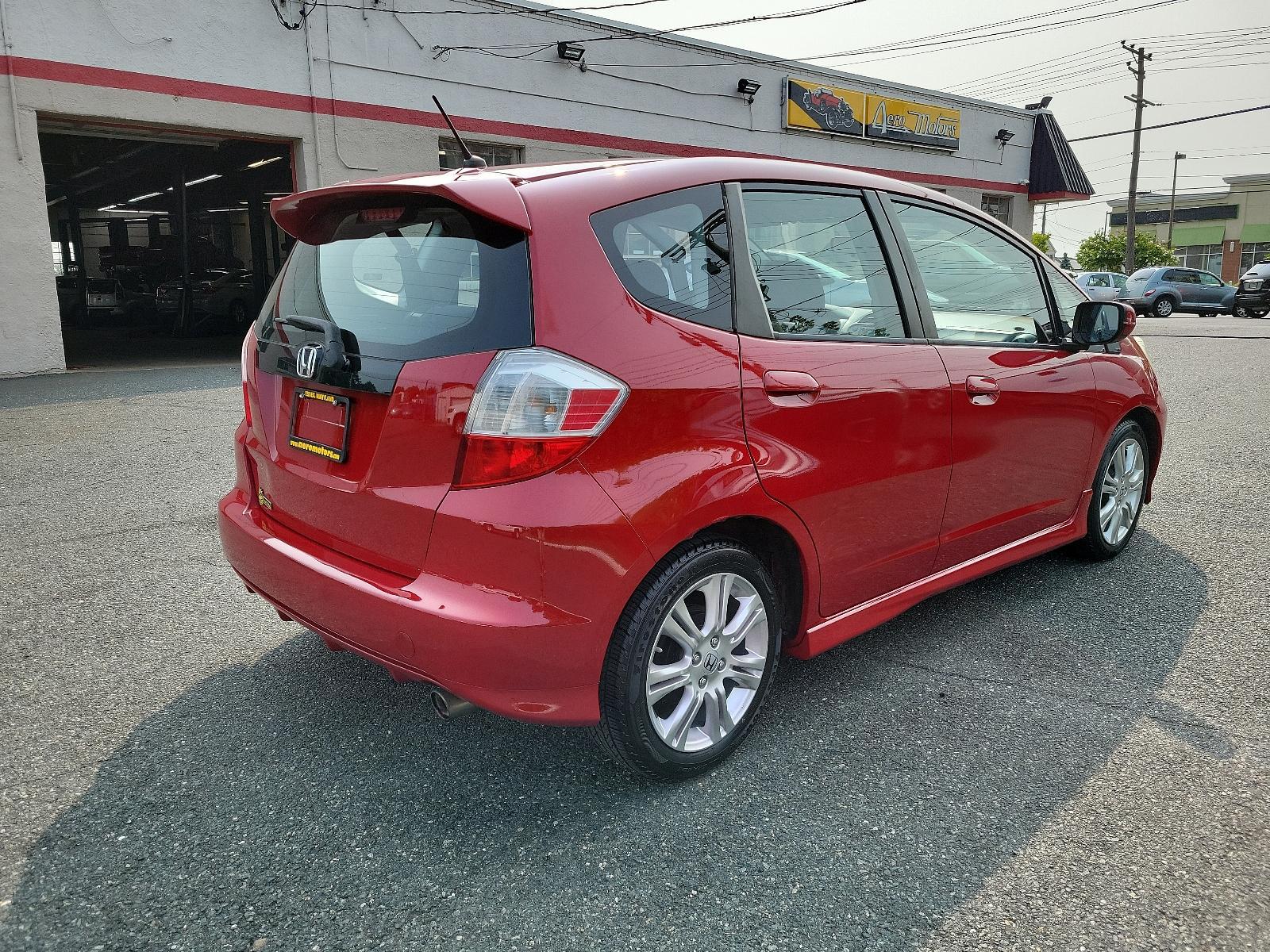 2009 Milano Red - RE /Black - BK Honda Fit Sport w/Navi (JHMGE88629S) with an 1.5L SOHC MPFI 16-valve i-VTEC I4 engine engine, located at 50 Eastern Blvd., Essex, MD, 21221, (410) 686-3444, 39.304367, -76.484947 - <p>Drive in style with our impressive 2009 Honda Fit Sport shown in Milano Red. Powered by an efficient 1.5 Liter 4 Cylinder that offers 117hp and is connected to a 5 Speed Automatic transmission. This Front Wheel Drive is sure to please any driver as it rewards you with nearly 33mpg on the highway. - Photo #3
