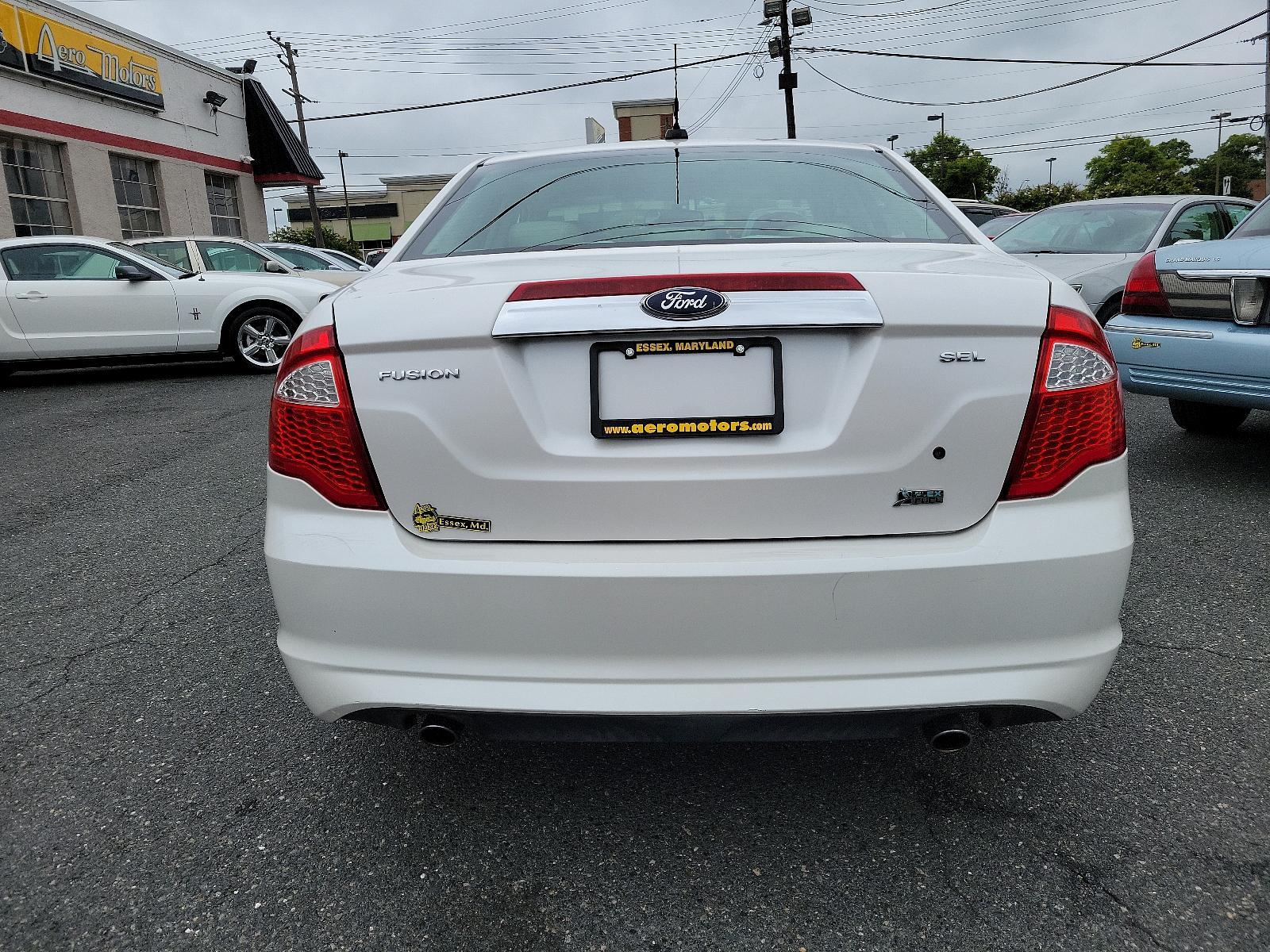 2010 White Platinum Metallic Tri-Coat - UG /Medium Light Stone - DL Ford Fusion SEL (3FAHP0JG8AR) with an 3.0L 24V V6 DURATEC FLEX FUEL ENGINE engine, located at 50 Eastern Blvd., Essex, MD, 21221, (410) 686-3444, 39.304367, -76.484947 - <p>Our great looking 2010 Ford Fusion SEL Sedan in White Platinum Metallic offers fuel efficiency, a spacious cabin, ride comfort, and great handling. Powered by a 3.0 Liter V6 that generates an impressive 240hp paired with a responsive 6 Speed Automatic transmission. This Front Wheel Drive is incre - Photo #4