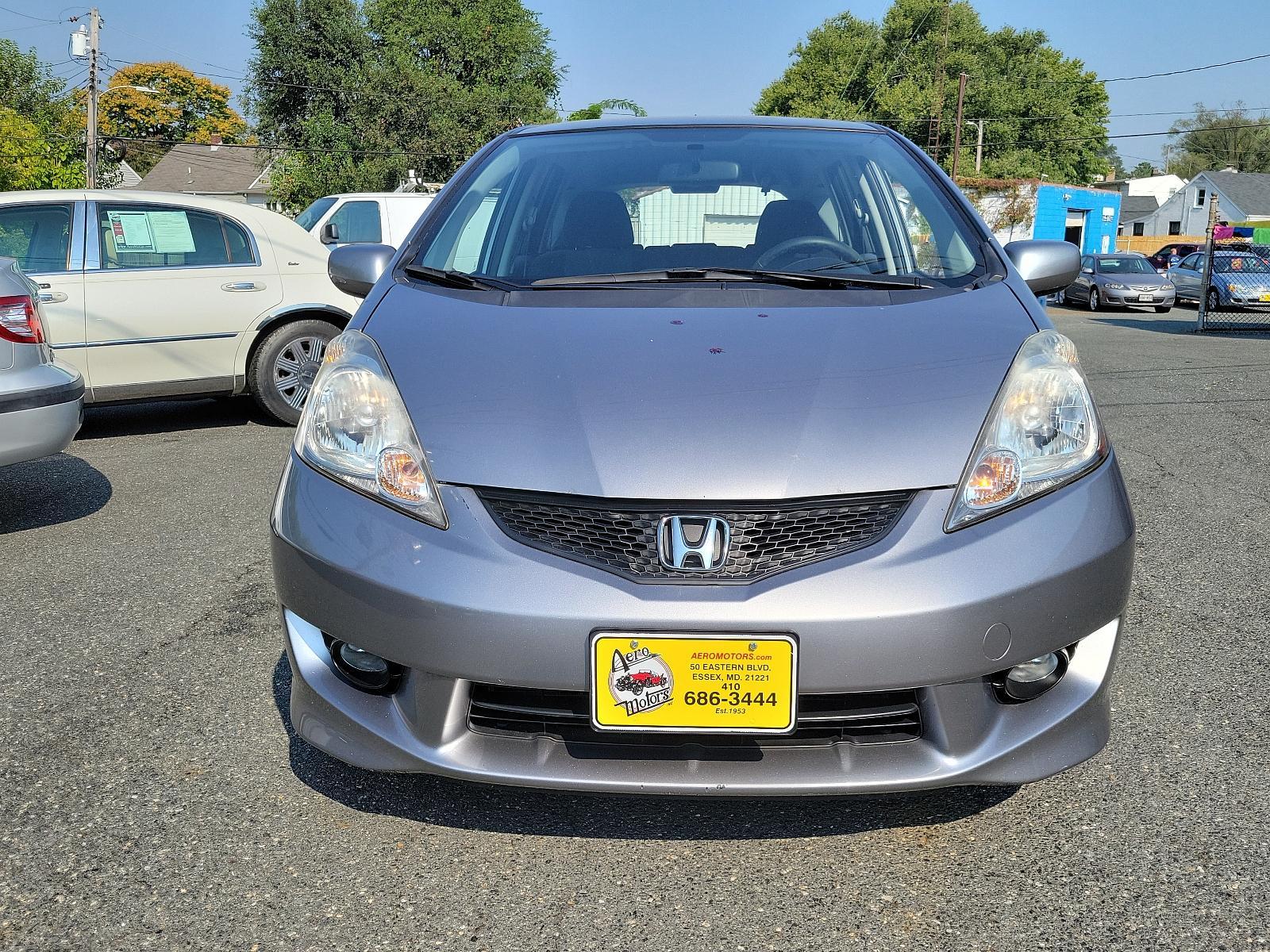 2009 Storm Silver Metallic - SI /Black - BK Honda Fit Sport w/Navi (JHMGE87689S) with an 1.5L SOHC MPFI 16-valve i-VTEC I4 engine engine, located at 50 Eastern Blvd., Essex, MD, 21221, (410) 686-3444, 39.304367, -76.484947 - <p>Check out this lively 2009 Honda Fit Sport on display in Storm Silve Metallic! Powered by an energetic 1.5 Liter 4 Cylinder offering 117hp while paired to a 5 Speed Manual transmission. This Front Wheel Drive combination will reward you with nearly 33mpg on the highway! It's not often you find a - Photo #1