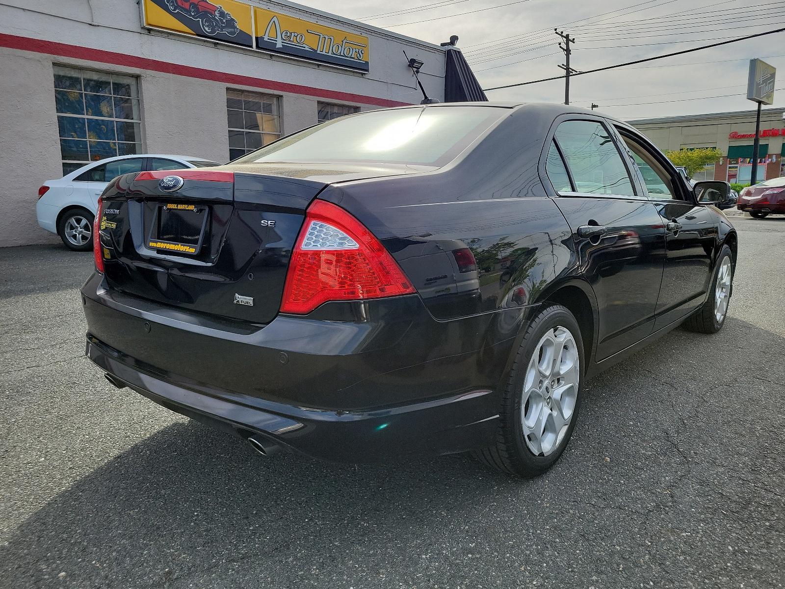 2010 Tuxedo Black Metallic - UH /Medium Light Stone - DL Ford Fusion SE (3FAHP0HG1AR) with an 3.0L 24V V6 DURATEC FLEX FUEL ENGINE engine, located at 50 Eastern Blvd., Essex, MD, 21221, (410) 686-3444, 39.304367, -76.484947 - Experience the perfect blend of style, comfort, and performance with this impeccable 2010 Ford Fusion SE Sedan. Showcased in sophisticated Tuxedo Black Metallic paintwork, this 4-door delight boasts a Medium Light Stone interior that promotes a sophisticated environment. Under the hood, you'll disco - Photo #3