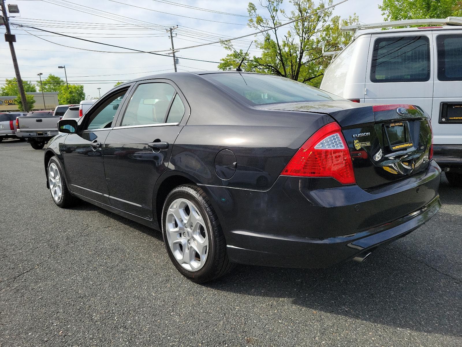 2010 Tuxedo Black Metallic - UH /Medium Light Stone - DL Ford Fusion SE (3FAHP0HG1AR) with an 3.0L 24V V6 DURATEC FLEX FUEL ENGINE engine, located at 50 Eastern Blvd., Essex, MD, 21221, (410) 686-3444, 39.304367, -76.484947 - Experience the perfect blend of style, comfort, and performance with this impeccable 2010 Ford Fusion SE Sedan. Showcased in sophisticated Tuxedo Black Metallic paintwork, this 4-door delight boasts a Medium Light Stone interior that promotes a sophisticated environment. Under the hood, you'll disco - Photo #5