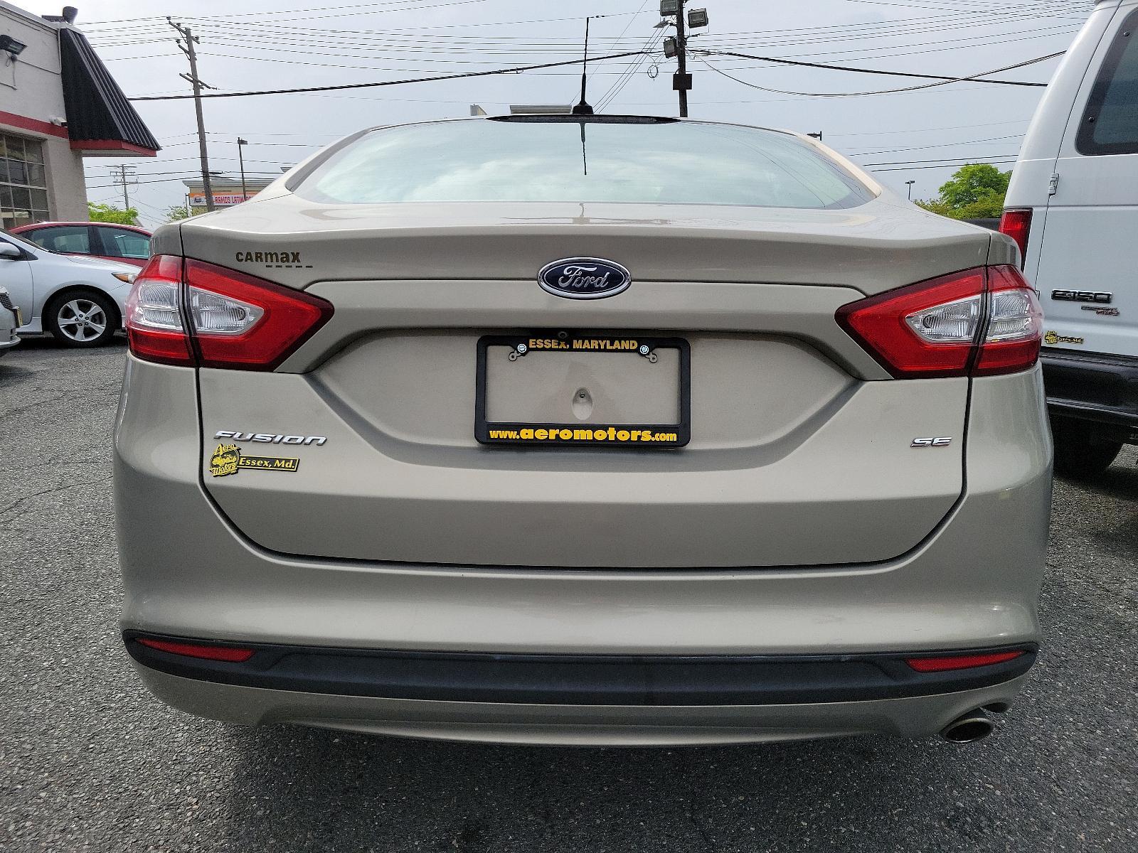 2015 Tectonic - HI /Dune - AQ Ford Fusion SE (3FA6P0H71FR) with an ENGINE: 2.5L IVCT engine, located at 50 Eastern Blvd., Essex, MD, 21221, (410) 686-3444, 39.304367, -76.484947 - Experience the sophisticated blend of performance, efficiency, and style found in this 2015 Ford Fusion SE 4dr sdn se fwd. Unmistakably eye-catching with a sleek Tectonic-hi exterior, it exudes refinement and ivct technology with its sturdy 2.5L engine. This impressive engine ensures smooth, respons - Photo #4