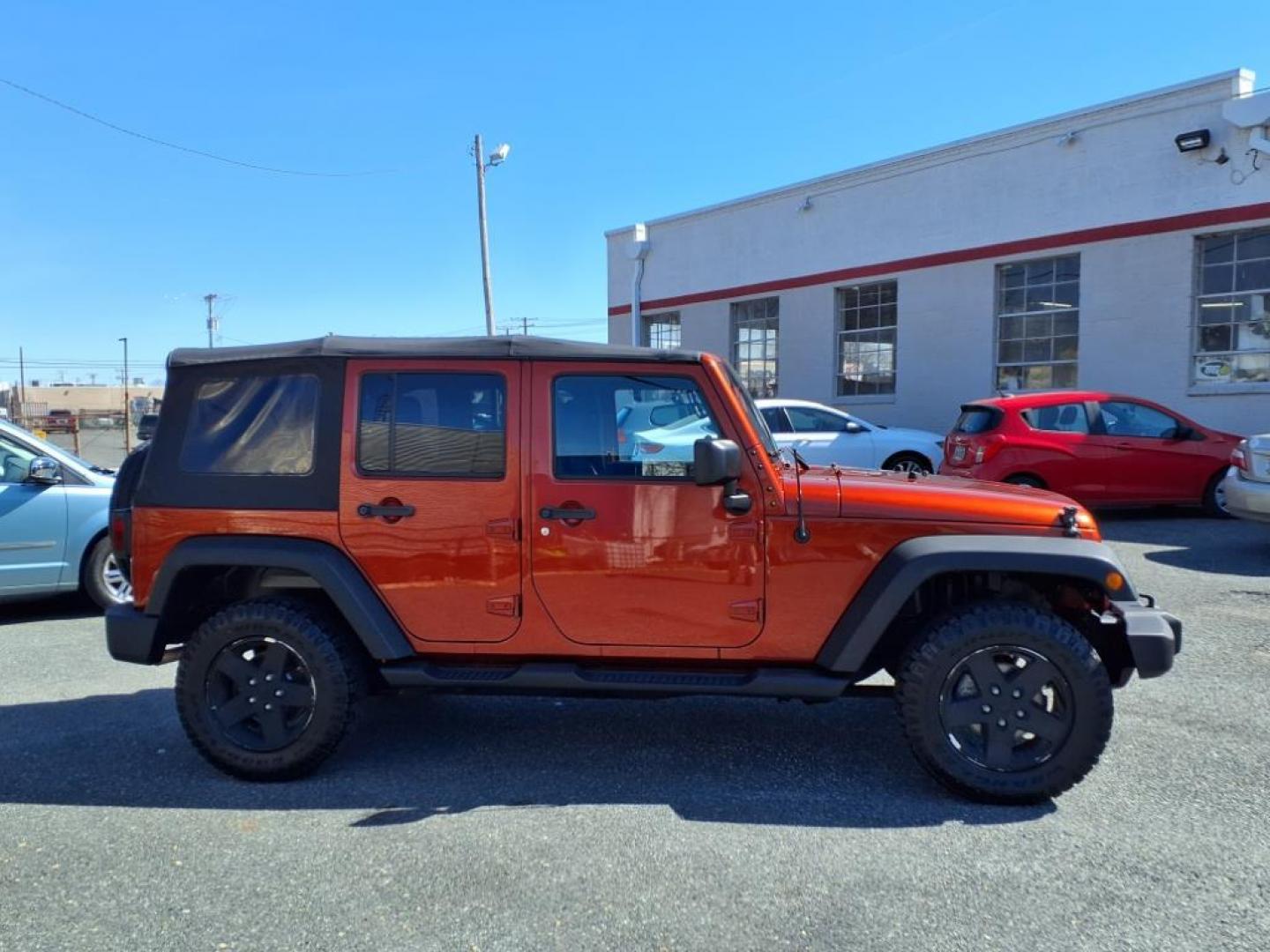 2014 Copperhead Pearl Coat Jeep Wrangler Unlimited Sport (1C4BJWDG4EL) with an 3.6L 6 Cylinder Sequential-Port F.I. engine, 5-Speed Automatic transmission, located at 50 Eastern Blvd., Essex, MD, 21221, (410) 686-3444, 39.304367, -76.484947 - Photo#5