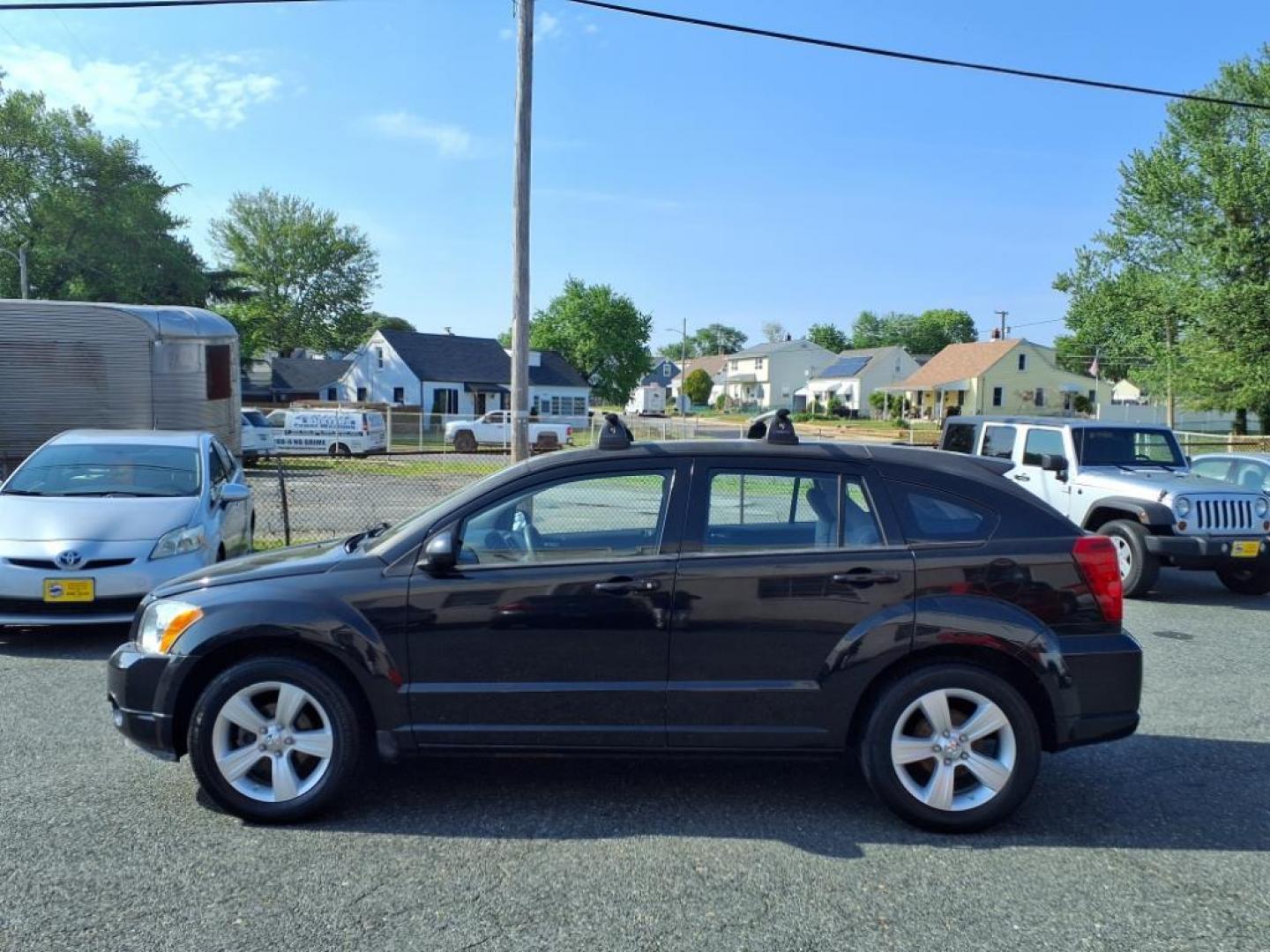 2011 Black Dodge Caliber Mainstreet (1B3CB3HAXBD) with an 2.0L 4 Cylinder Sequential-Port F.I. engine, 4CYL AT transmission, located at 50 Eastern Blvd., Essex, MD, 21221, (410) 686-3444, 39.304367, -76.484947 - Photo#1