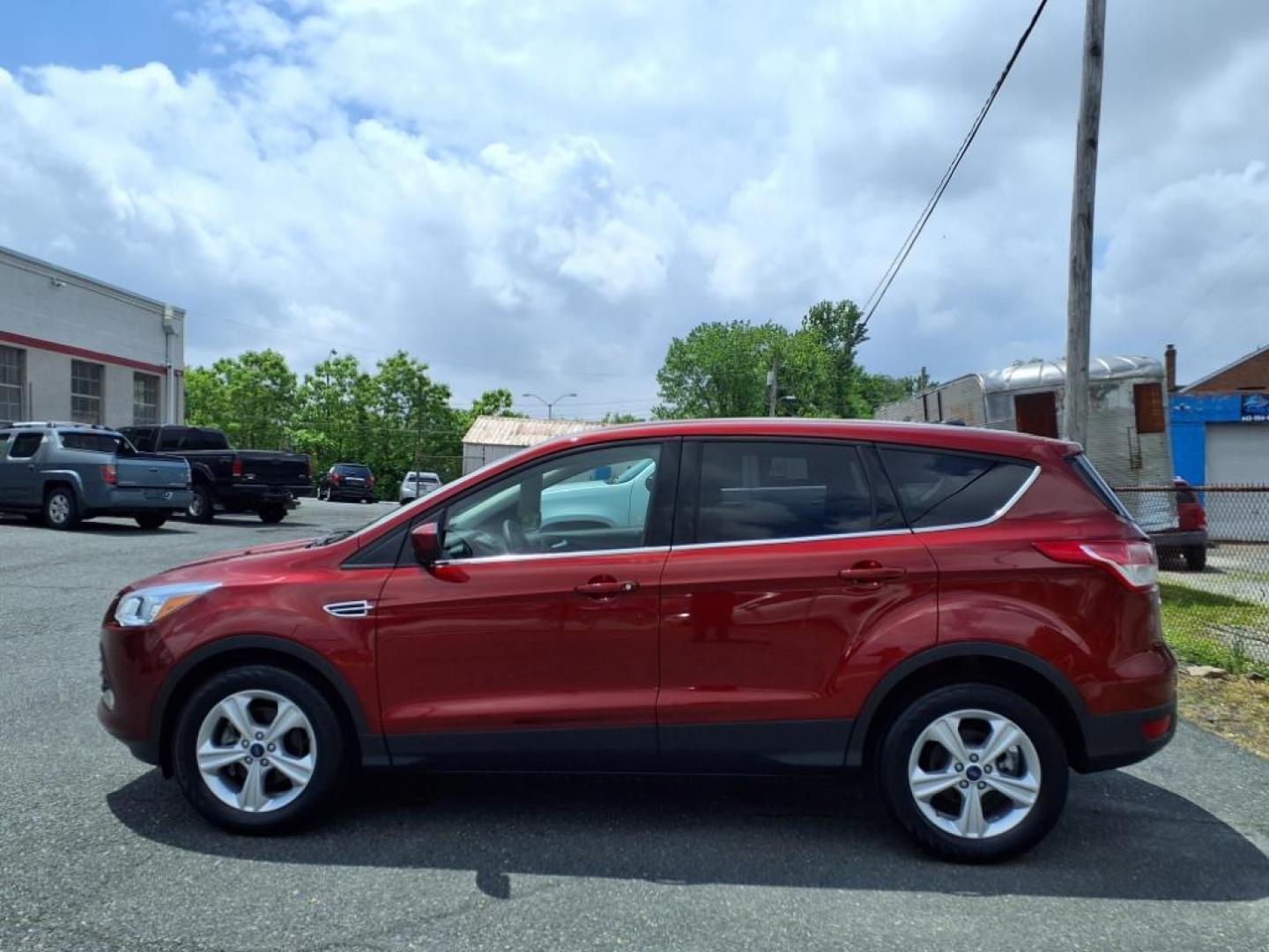 2014 Ruby Red Metallic Tinted Clearcoat Ford Escape SE (1FMCU0GX1EU) with an 1.6L 4 Cylinder Turbocharged engine, V6 AT transmission, located at 50 Eastern Blvd., Essex, MD, 21221, (410) 686-3444, 39.304367, -76.484947 - Photo#1