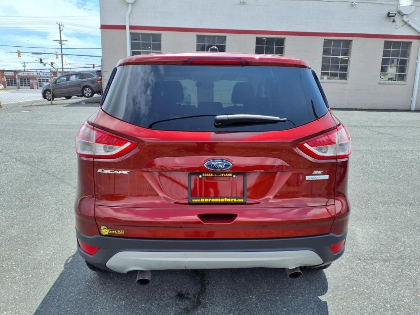 2014 Ruby Red Metallic Tinted Clearcoat Ford Escape SE (1FMCU0GX1EU) with an 1.6L 4 Cylinder Turbocharged engine, V6 AT transmission, located at 50 Eastern Blvd., Essex, MD, 21221, (410) 686-3444, 39.304367, -76.484947 - Photo#3