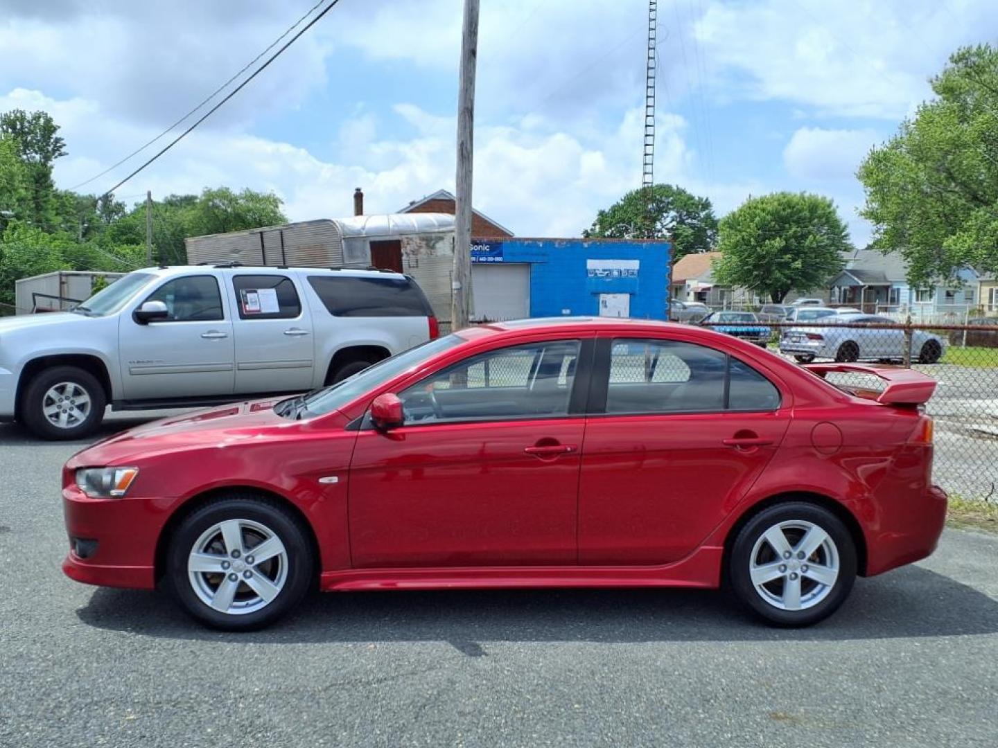 2009 Rally Red Metallic Mitsubishi Lancer ES Sport (JA3AU26U29U) with an 2.0L 2.0L I4 152hp 146ft. lbs. Sequential-Port F.I. engine, CVT transmission, located at 50 Eastern Blvd., Essex, MD, 21221, (410) 686-3444, 39.304367, -76.484947 - Photo#1