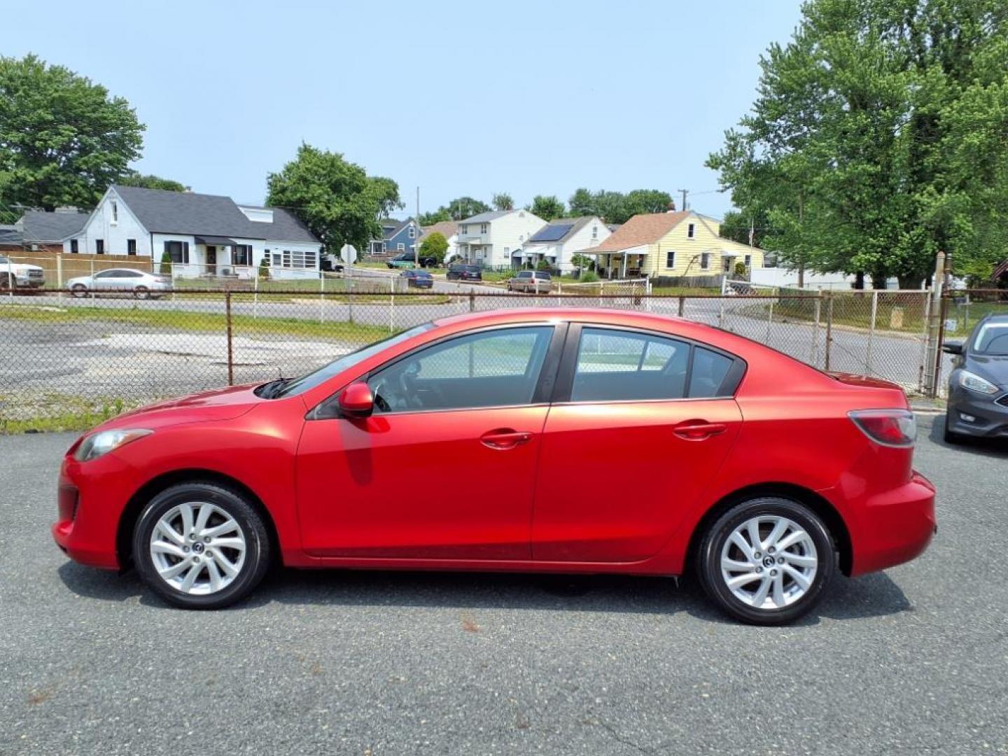 2013 Velocity Red Mazda Mazda3 i Touring (JM1BL1VPXD1) with an 2.0L SKYACTIV-G 2.0L I4 155hp 148ft. lbs. Sequential-Port F.I. engine, 6-Speed Shiftable Automatic transmission, located at 50 Eastern Blvd., Essex, MD, 21221, (410) 686-3444, 39.304367, -76.484947 - Photo#1