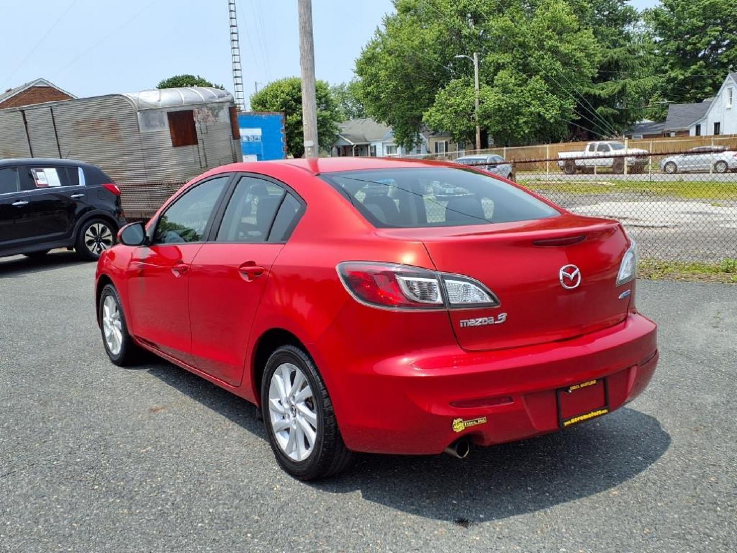 2013 Velocity Red Mazda Mazda3 i Touring (JM1BL1VPXD1) with an 2.0L SKYACTIV-G 2.0L I4 155hp 148ft. lbs. Sequential-Port F.I. engine, 6-Speed Shiftable Automatic transmission, located at 50 Eastern Blvd., Essex, MD, 21221, (410) 686-3444, 39.304367, -76.484947 - Photo#2