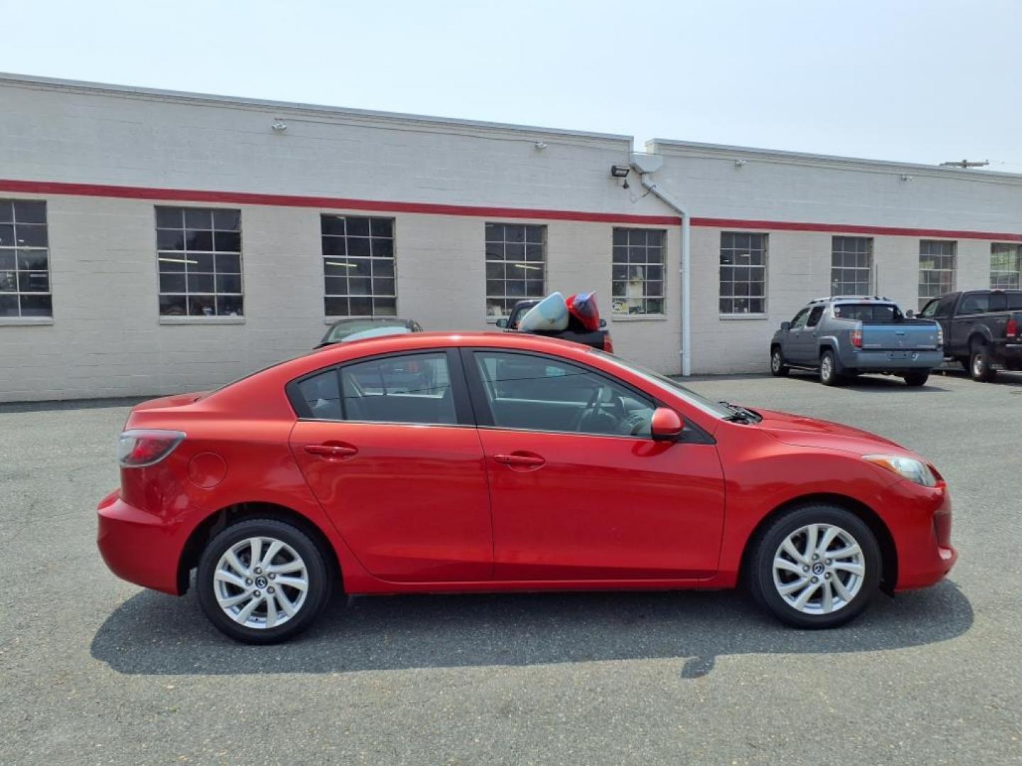 2013 Velocity Red Mazda Mazda3 i Touring (JM1BL1VPXD1) with an 2.0L SKYACTIV-G 2.0L I4 155hp 148ft. lbs. Sequential-Port F.I. engine, 6-Speed Shiftable Automatic transmission, located at 50 Eastern Blvd., Essex, MD, 21221, (410) 686-3444, 39.304367, -76.484947 - Photo#5
