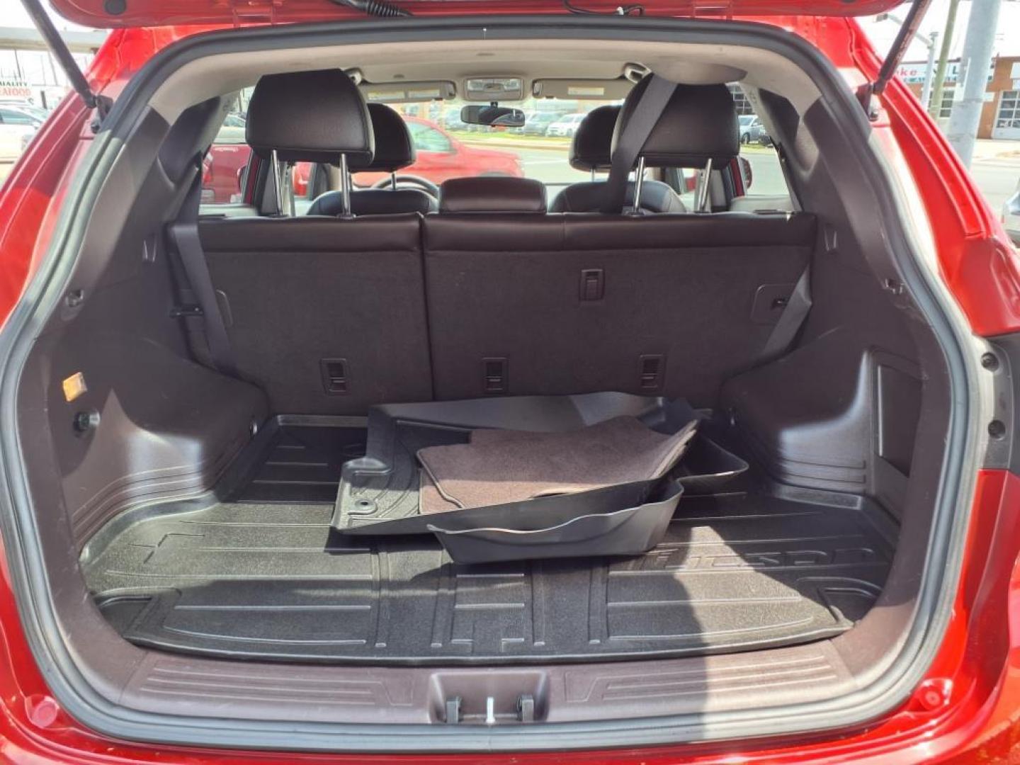 2013 Garnet Red Mica Hyundai TUCSON Limited (KM8JU3AC6DU) with an 2.4L 2.4L I4 176hp 168ft. lbs. Sequential-Port F.I. engine, 6-Speed Shiftable Automatic transmission, located at 50 Eastern Blvd., Essex, MD, 21221, (410) 686-3444, 39.304367, -76.484947 - Photo#4