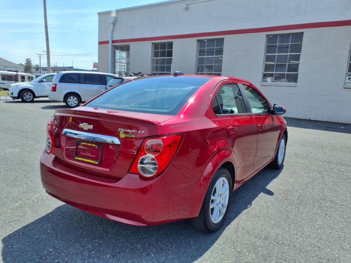 2015 Red Hot Chevrolet Sonic LT Auto (1G1JC5SG6F4) with an 1.8L 4 Cylinder Sequential-Port F.I. engine, AT 4CYL transmission, located at 50 Eastern Blvd., Essex, MD, 21221, (410) 686-3444, 39.304367, -76.484947 - Photo#4