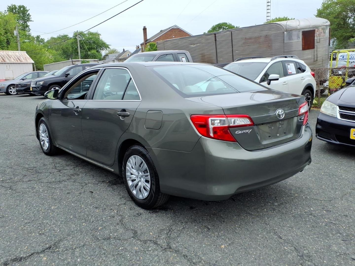 2014 Green Toyota Camry (4T4BF1FK3ER) with an 2.5L 4 Cylinder Sequential-Port F.I. engine, Automatic transmission, located at 50 Eastern Blvd., Essex, MD, 21221, (410) 686-3444, 39.304367, -76.484947 - Photo#2