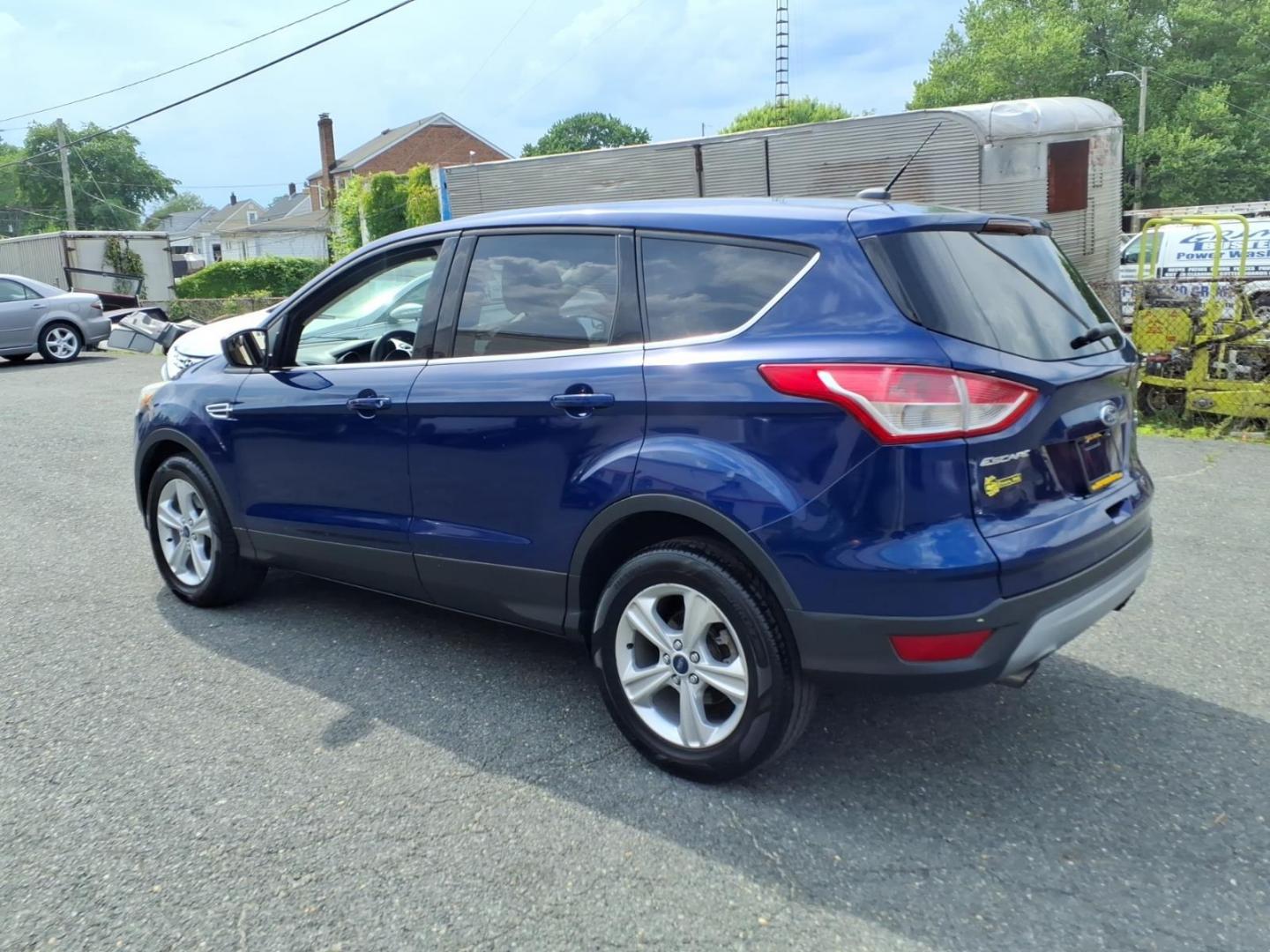 2014 Deep Impact Blue Metallic Ford Escape SE (1FMCU9G9XEU) with an 2.0L EcoBoost 2.0L Turbo I4 240hp 270ft. lbs. Turbocharged engine, 6-Speed Shiftable Automatic transmission, located at 50 Eastern Blvd., Essex, MD, 21221, (410) 686-3444, 39.304367, -76.484947 - Photo#2