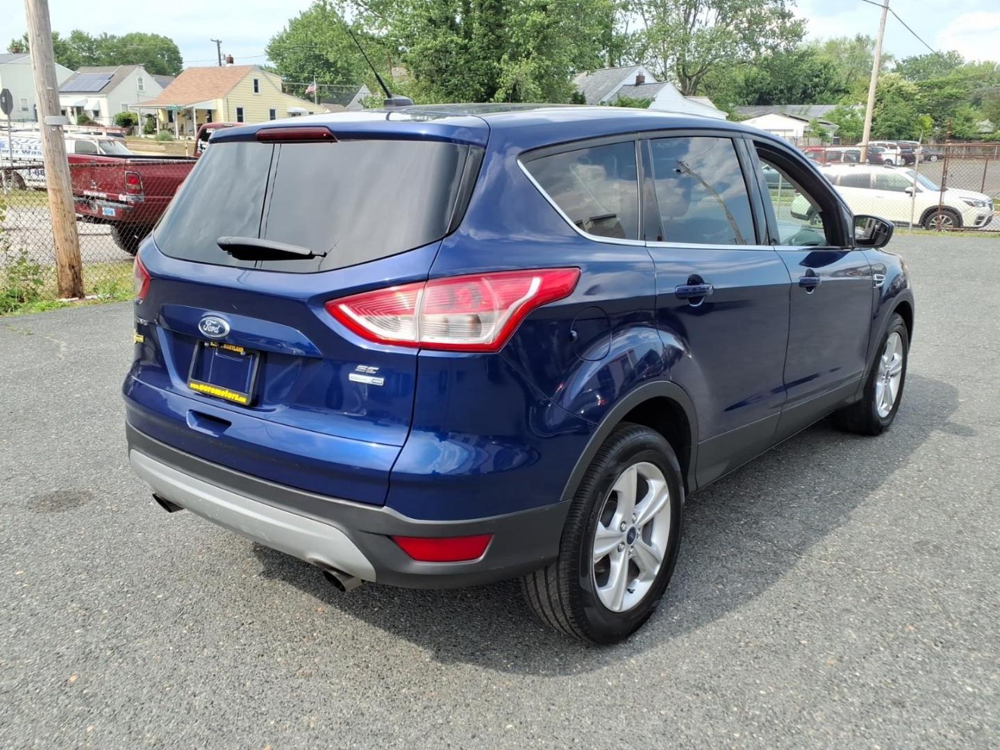 2014 Deep Impact Blue Metallic Ford Escape SE (1FMCU9G9XEU) with an 2.0L EcoBoost 2.0L Turbo I4 240hp 270ft. lbs. Turbocharged engine, 6-Speed Shiftable Automatic transmission, located at 50 Eastern Blvd., Essex, MD, 21221, (410) 686-3444, 39.304367, -76.484947 - Photo#4