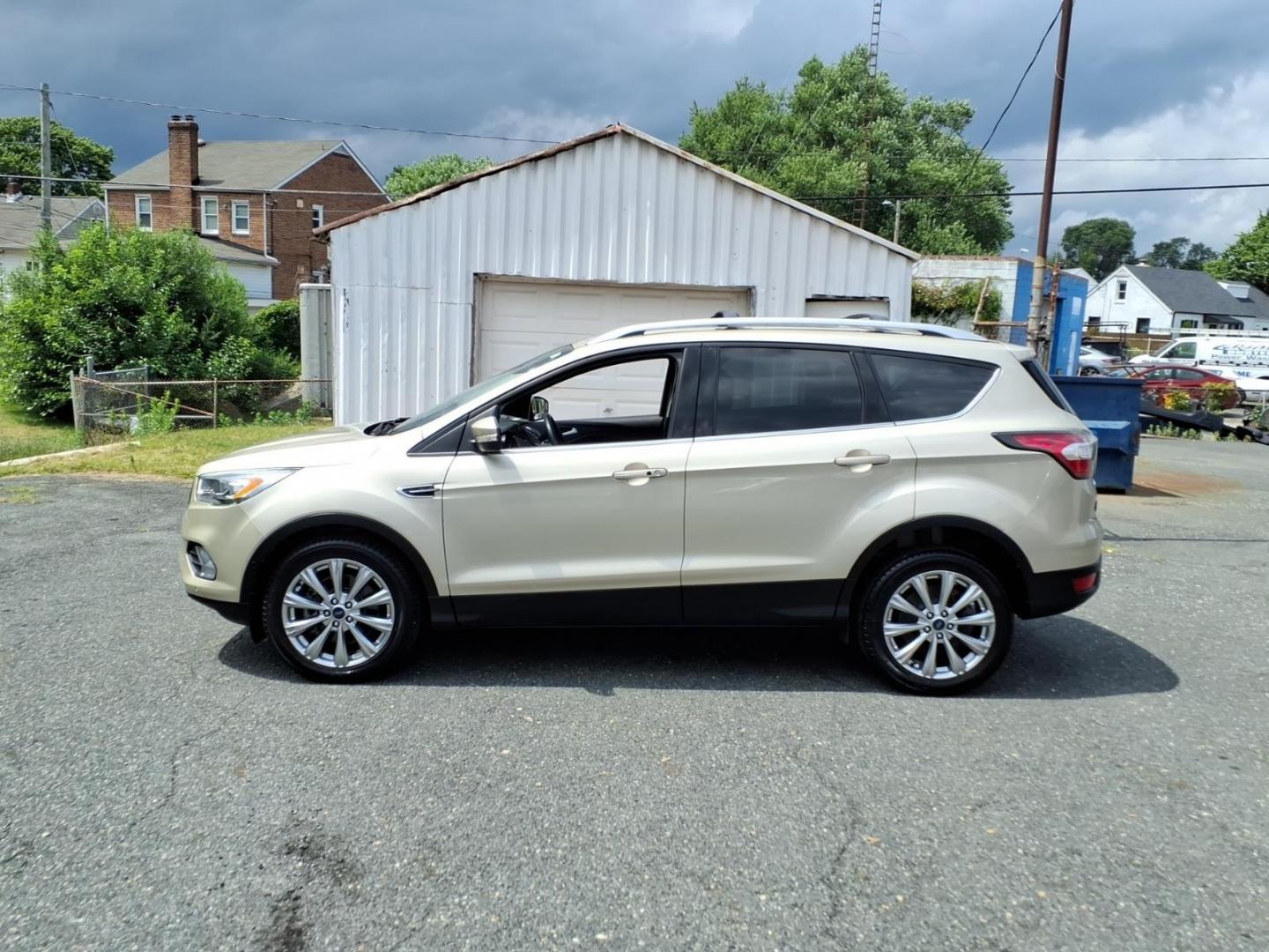 2017 White Gold Ford Escape Titanium (1FMCU9J95HU) with an 2.0L 4 Cylinder Turbocharged engine, ATAWD transmission, located at 50 Eastern Blvd., Essex, MD, 21221, (410) 686-3444, 39.304367, -76.484947- Photo#1