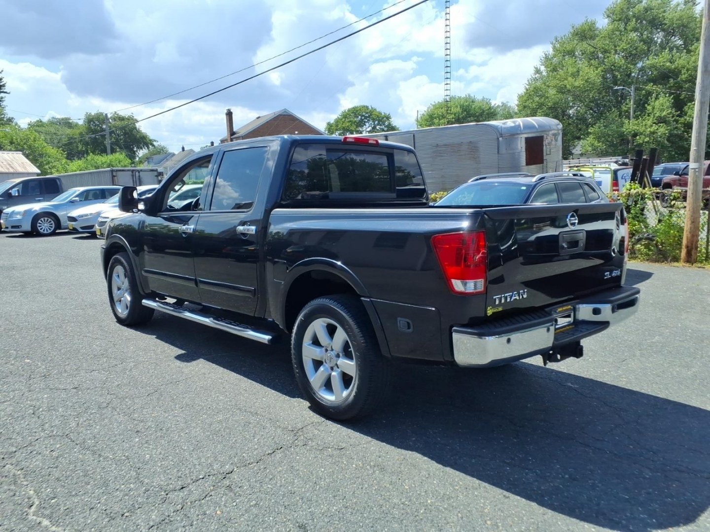 2014 Black Nissan Titan SL (1N6AA0EC6EN) with an 5.6L 8 Cylinder Fuel Injected engine, AT4X4 transmission, located at 50 Eastern Blvd., Essex, MD, 21221, (410) 686-3444, 39.304367, -76.484947- Photo#2