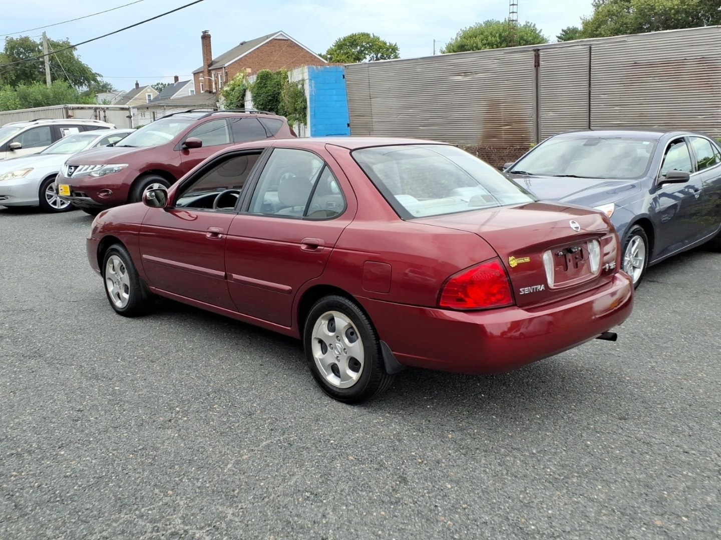 2005 Code Red Nissan Sentra 1.8 S (3N1CB51D55L) with an 1.8L 1L NA I4 double overhead cam (DOHC) 16V Fuel Injected engine, 4-Speed Automatic transmission, located at 50 Eastern Blvd., Essex, MD, 21221, (410) 686-3444, 39.304367, -76.484947- Photo#2